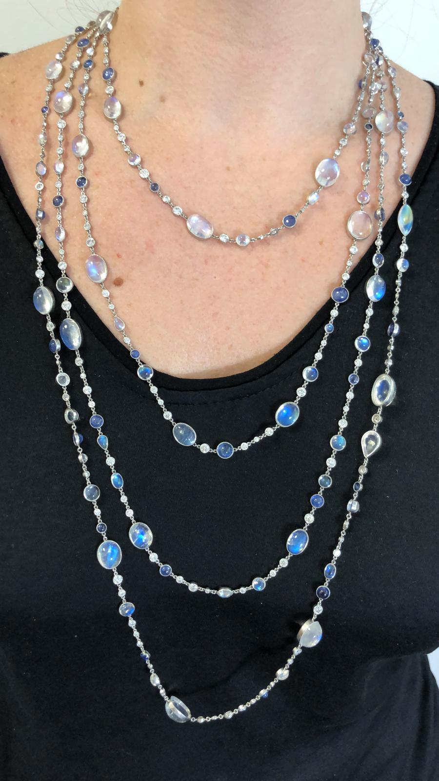 Transparent moonstone oval cabochons of exceptional adularescence are the focal point of this stunning long necklace. Tones of color are heightened by cornflower and ceylon blue round cabochon sapphires. In addition, faceted round brilliant cut