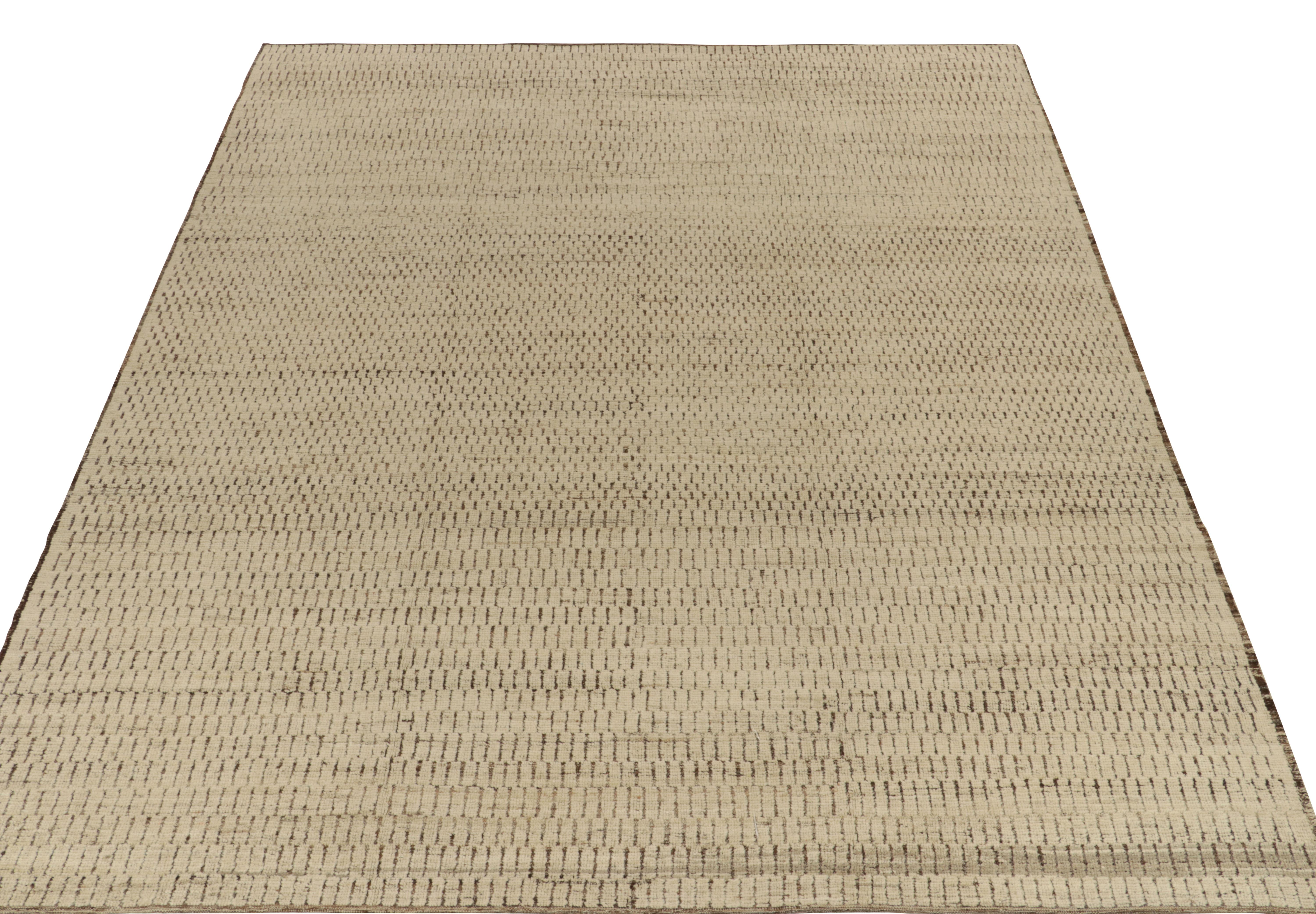 Rug & Kilim presents a contemporary take on Moroccan style with this 10x12 hand-knotted wool piece of sublime texture. The rug enjoys a comfortable high low appeal in forgiving beige brown geometric pattern manifesting as a close knit brick wall