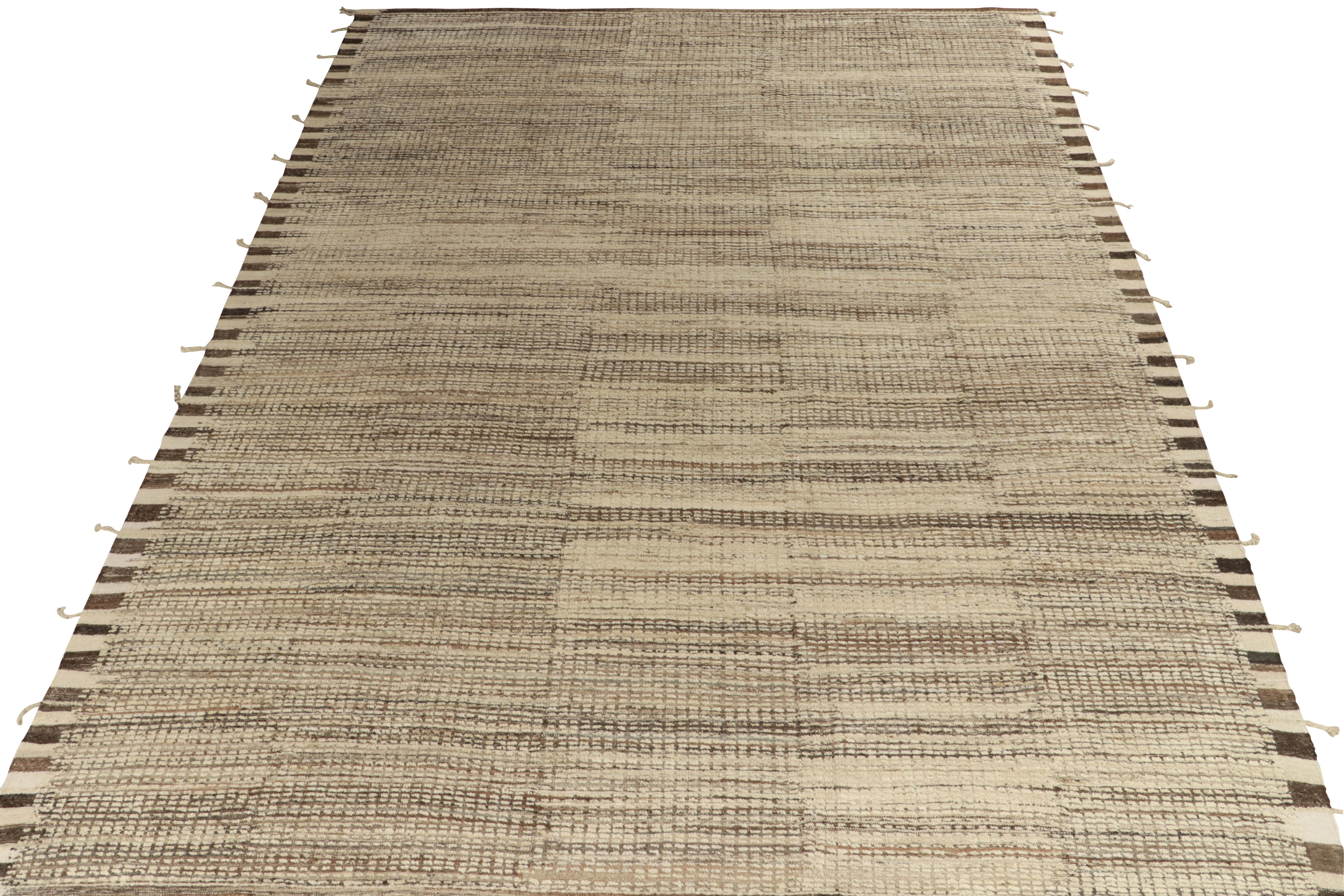 Rug & Kilim presents a contemporary take on Moroccan style with this 10x13 hand-knotted piece of exceptional texture. The rug enjoys a comfortable high-low appeal in forgiving beige brown black striations concluding to fringes on the borders for