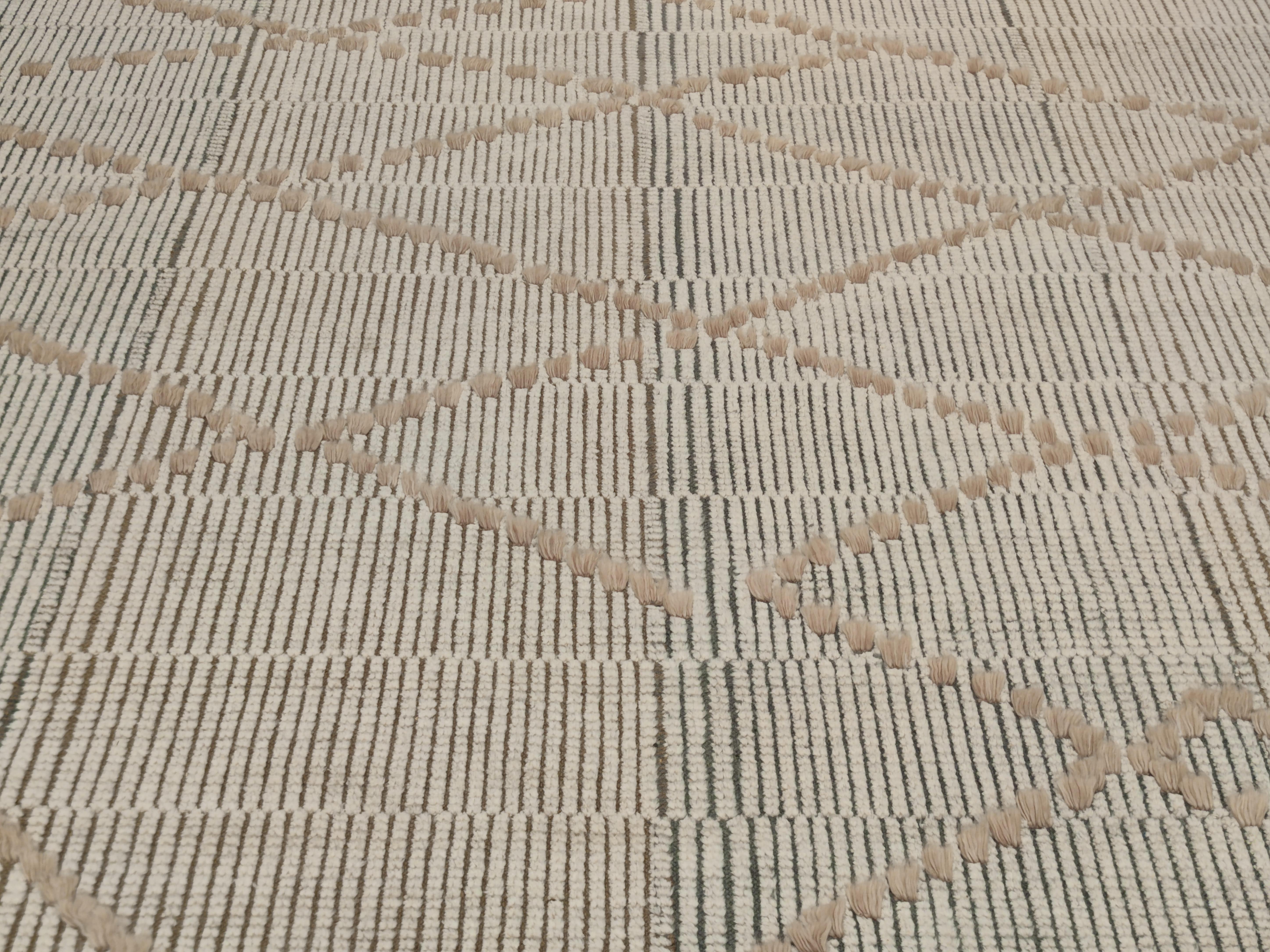 Temara represents the pinnacle of contemporary Moroccan collection offered by the Alberto Levi Gallery. Here the warps are arranged in four alternating clusters of blue-grey and brown, contrasting against the white wool background, sheared low in