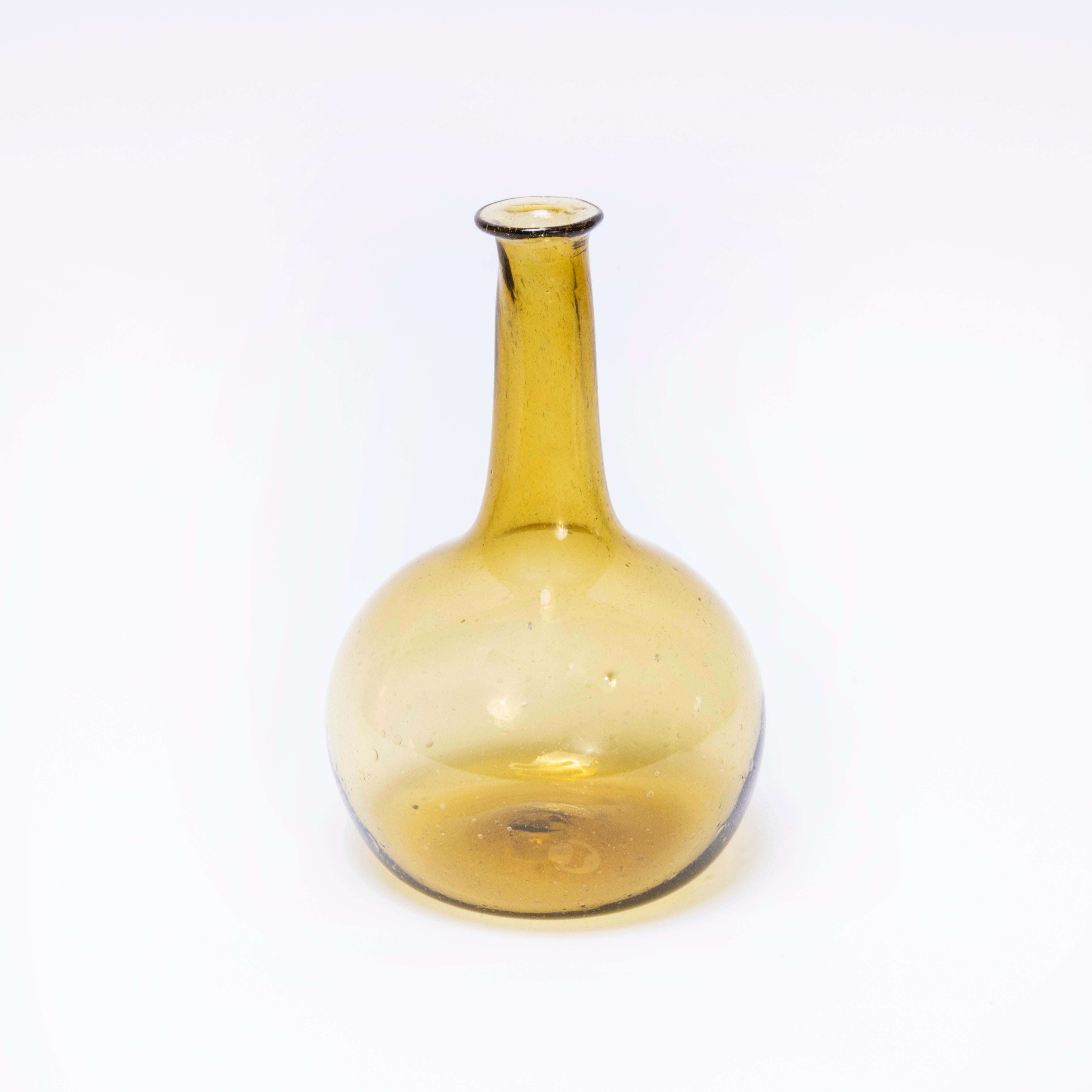 Contemporary Mouth Blown Moroccan Carafe - Ochre. 

Hand-made in Morocco. The glass is mouth blown and available in a beautiful ochre colour. Due to the artisanal quality of production colours may vary. 

Listing is for one jug.

Workshop