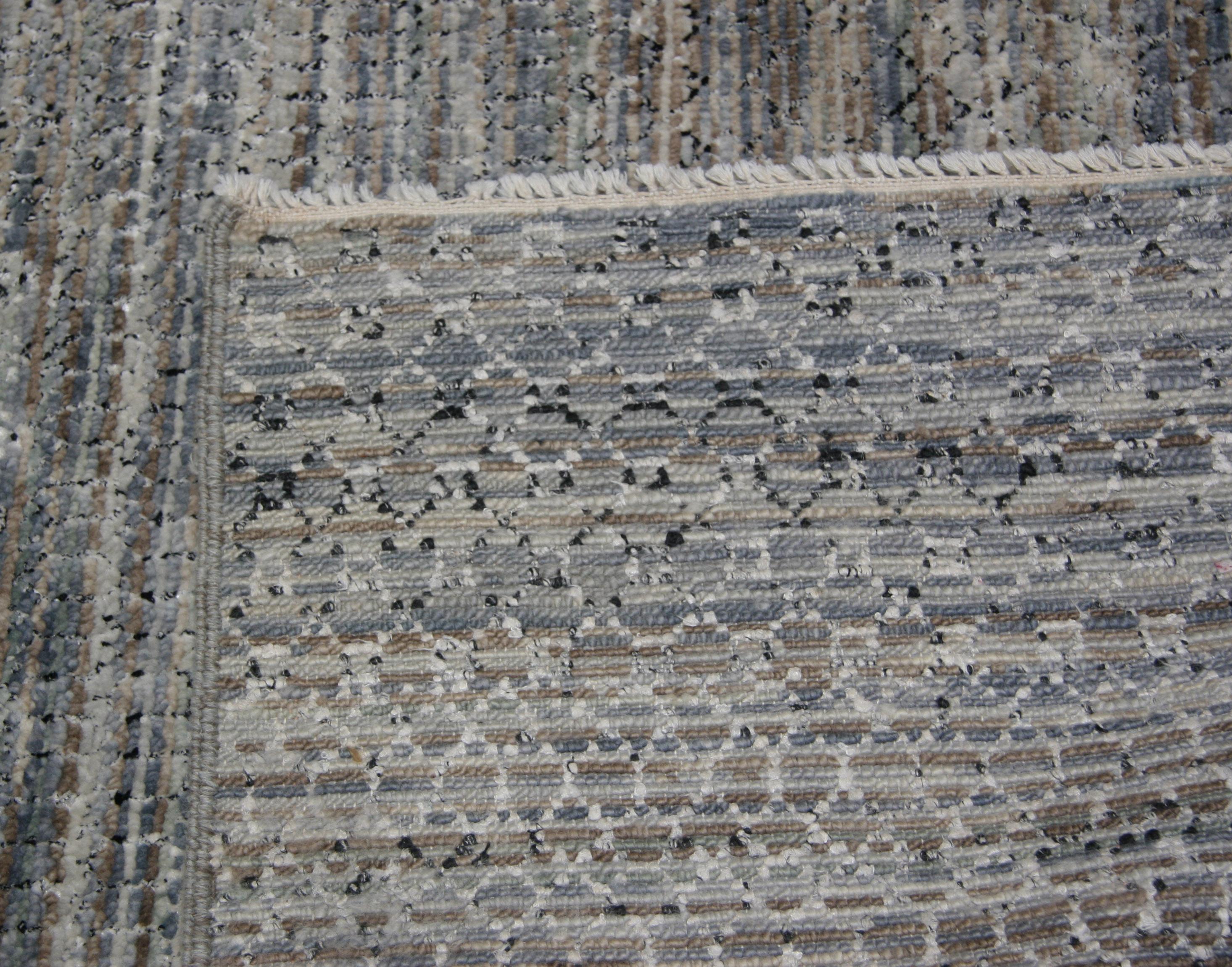 Subtle colors and pattern come together to create a contemporary take on the traditional gabbeh grass style. A closer look reveals shades of gray, silver, brown, blue and seafoam green -- a perfect fit with a wide range of current decor trends.