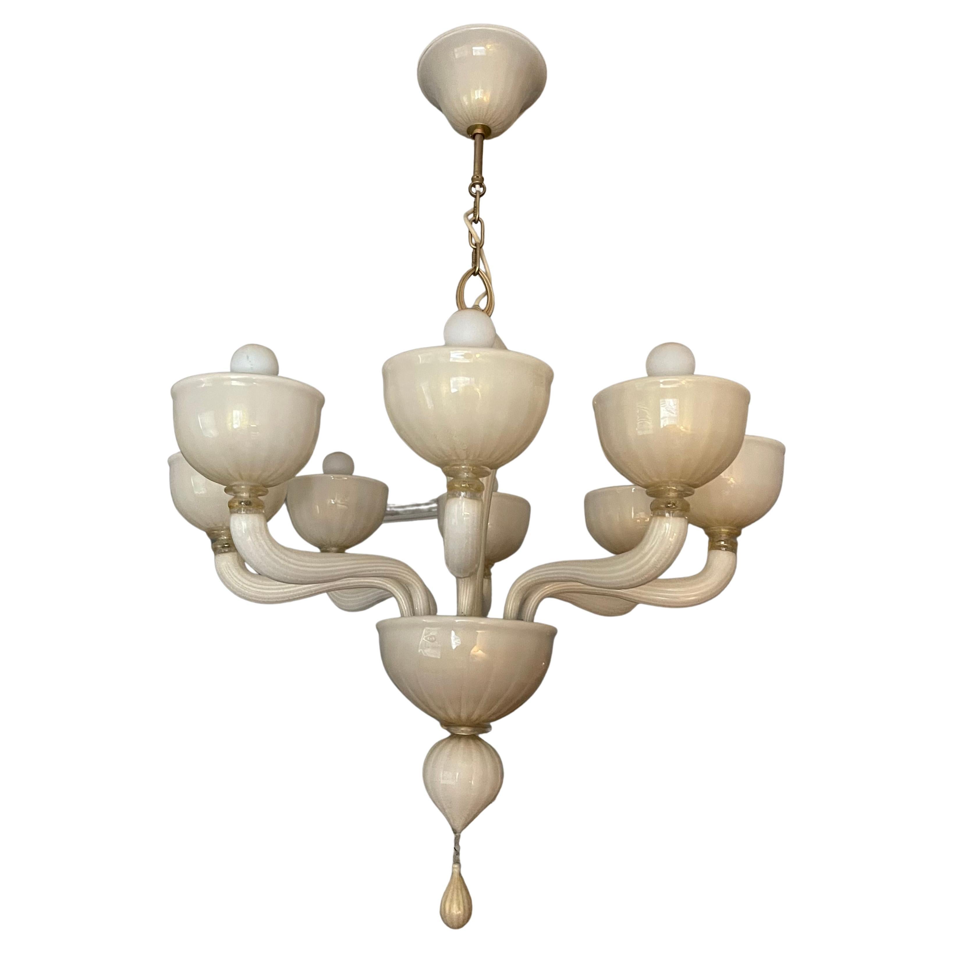 Large eight light Murano glass chandelier. Pale gold blown glass with gold flecks throughout. Wired and in working condition. Takes 8 chandelier bulbs (not included). This chandelier fully dissembles for delivery and can be shipped in boxes, please