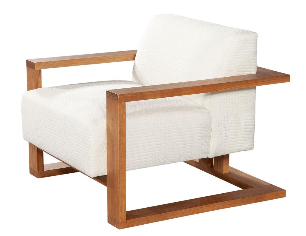 Contemporary natural oak lounge chair by Ellen Degeneres Parkdale Chair. Beautiful contemporary design with thick natural light show wood. Featuring plush seat and back cushions in a luxurious textured white linen. Price includes complimentary curb