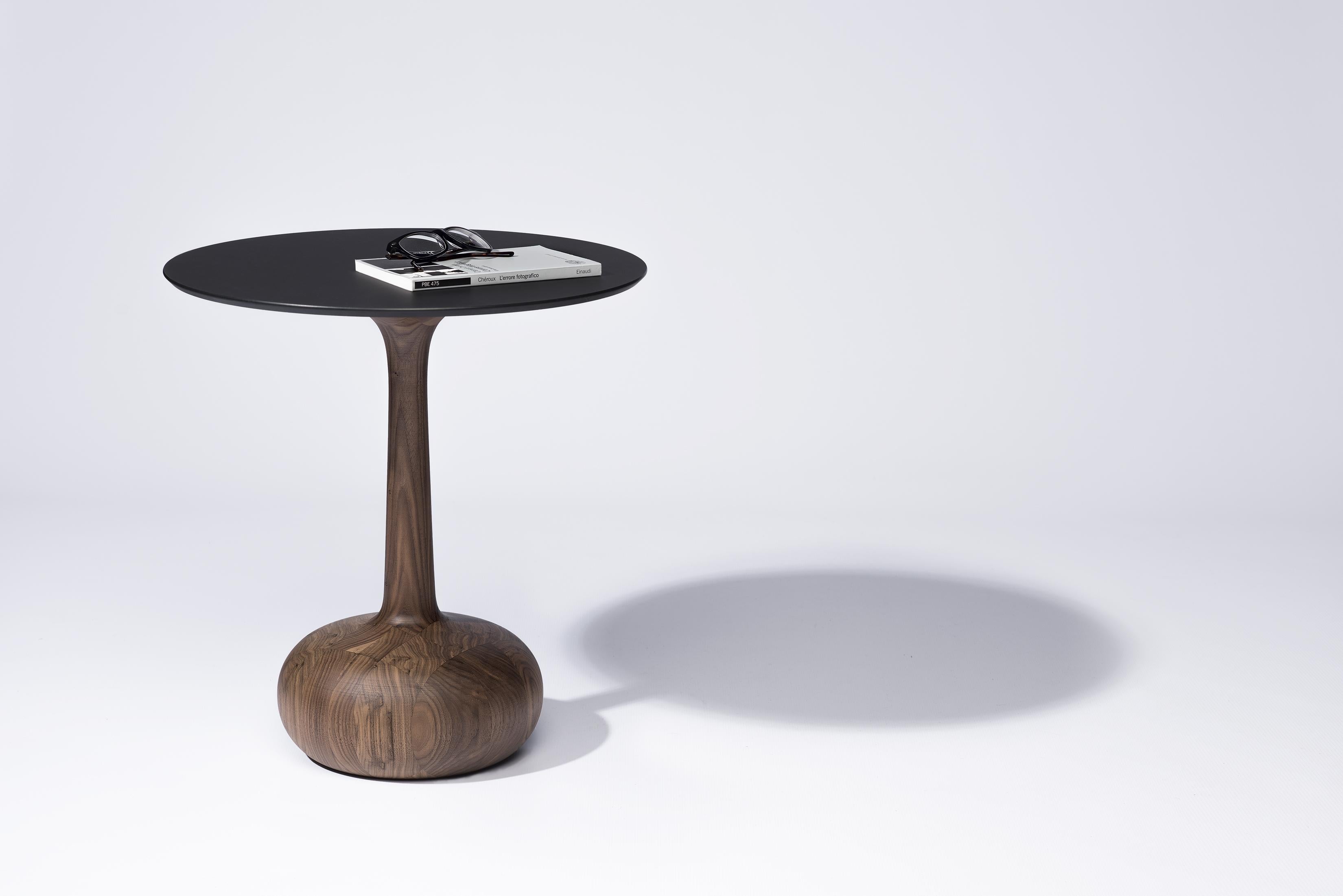 Ginevra

The expression of the finest Italian excellences

The coffee table has a base handcrafted of canaletto walnut and a round top of FENIX NTM®, a high-tech material treated with acrylic resins. The minimal design, with its bulky base,