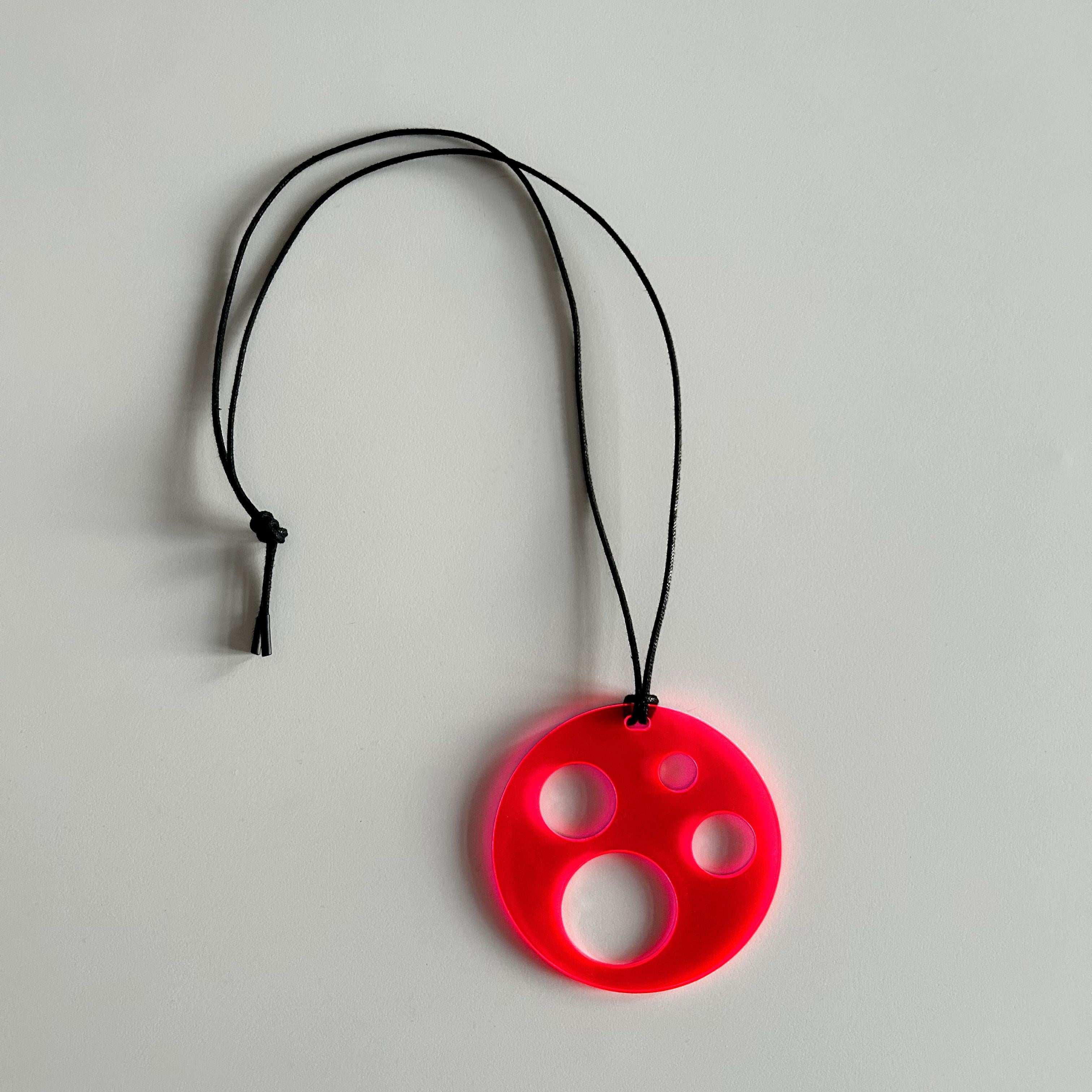 This modern necklace is a bold statement suitable for extravagant, modern, fashion-conscious people with an artistic consciousness. Lasered from fluorescent plexiglass, the edges of the necklace glow depending on the ambient light.
Necklace: Waxed