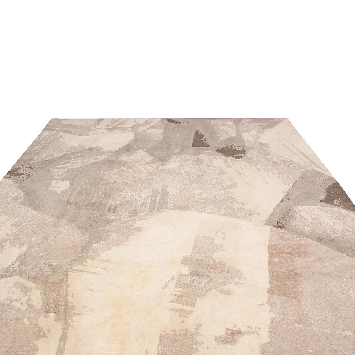 Hand knotted in one of the most reputed workshops in Nepal, this contemporary rug enjoys a chic, painterly field design complementing the warm-meets-rustic hues of beige and brown. The exceptional large-scale graph and subtle, natural sheen of
