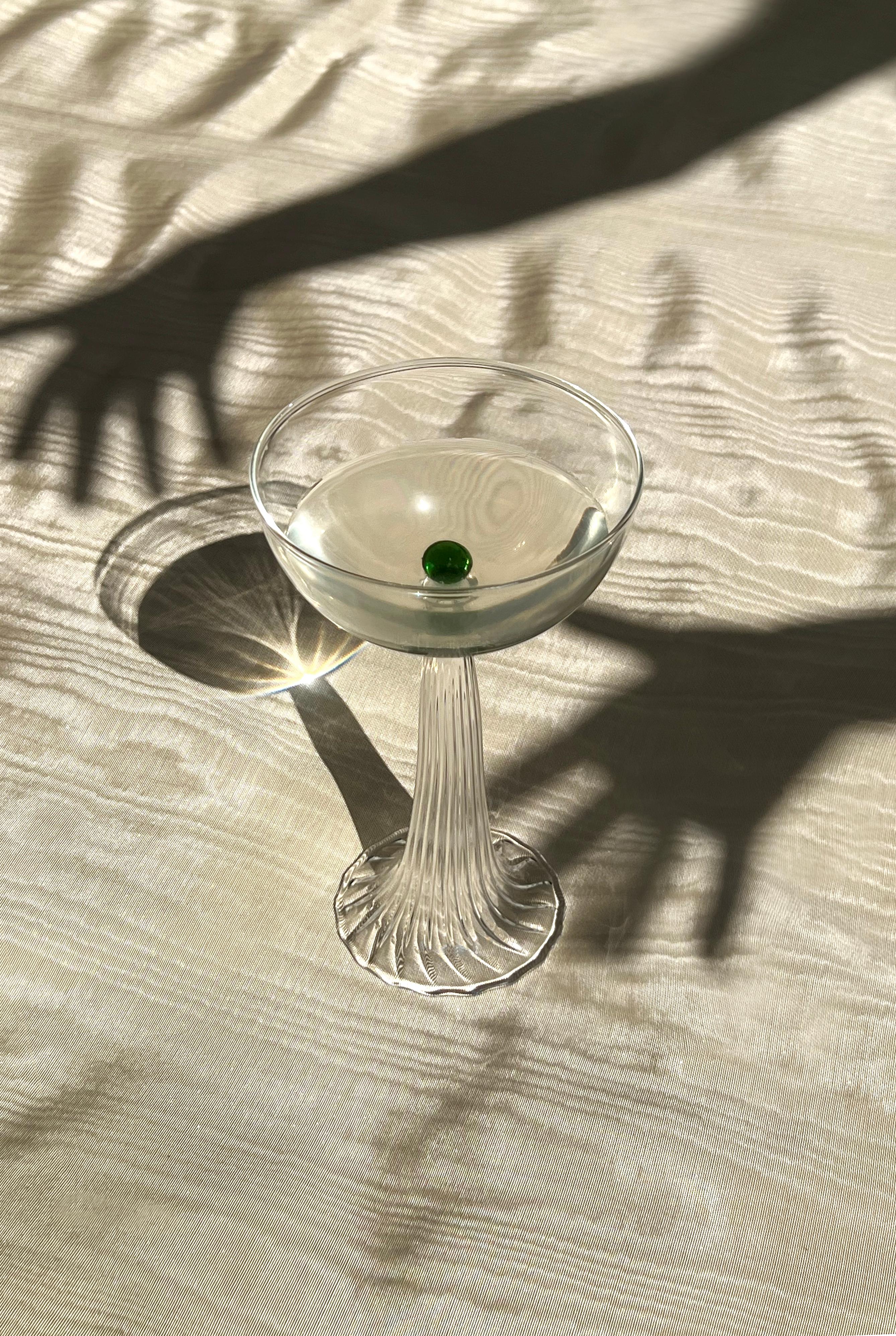 The  NEREIDA coupes reference an enchanting mythological undersea world. The highly sculptural design holds a delicate colored glass sphere, as a precious pearl.

Each piece is handmade in Italy by master glassblowers using high-quality borosilicate