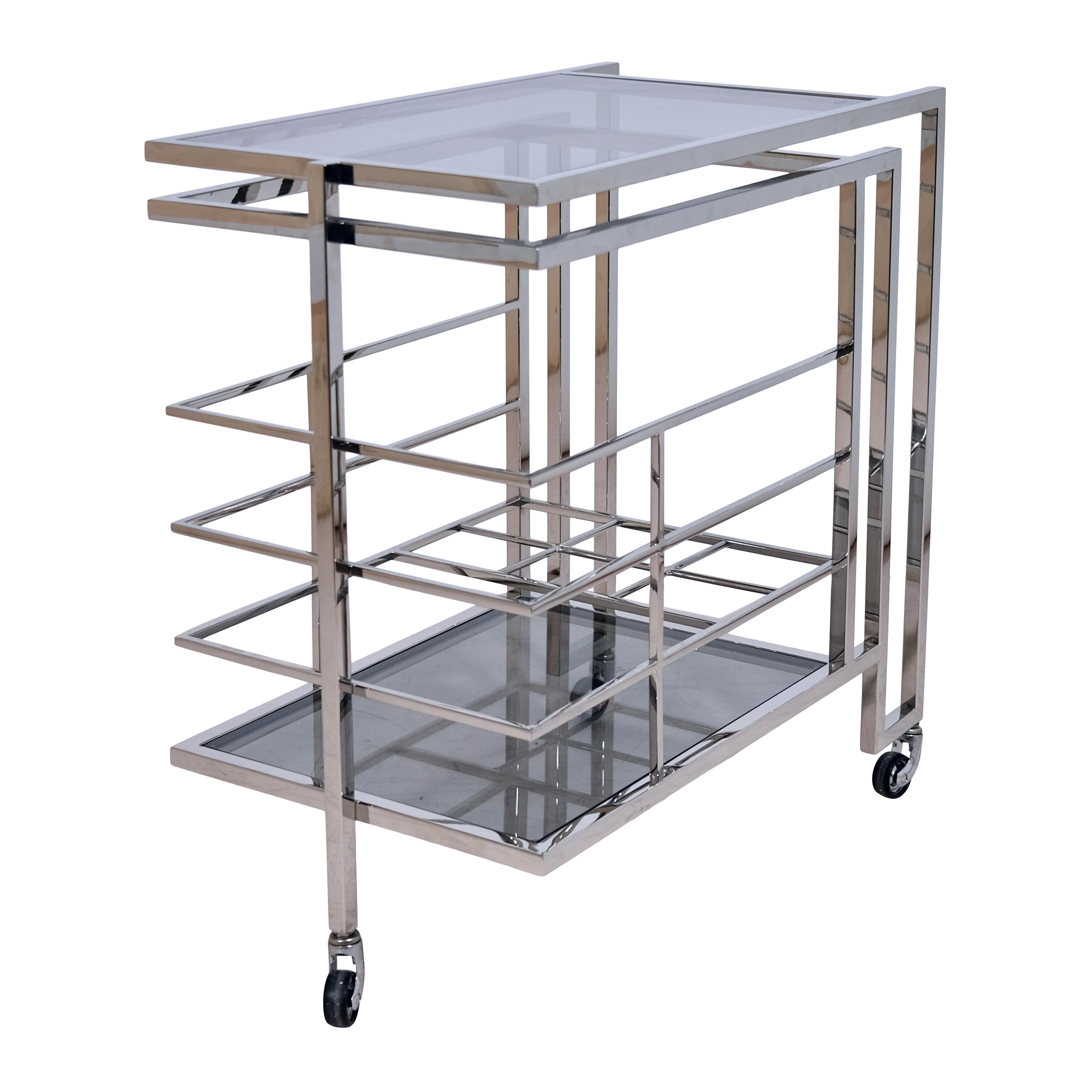 This modern bar cart, made of nickel-plated brass square tubes, is a perfect addition to your home, offering mobility and flexibility in your living room with its three wheels.

The design is inspired by a strict modernist style in the spirit of Art