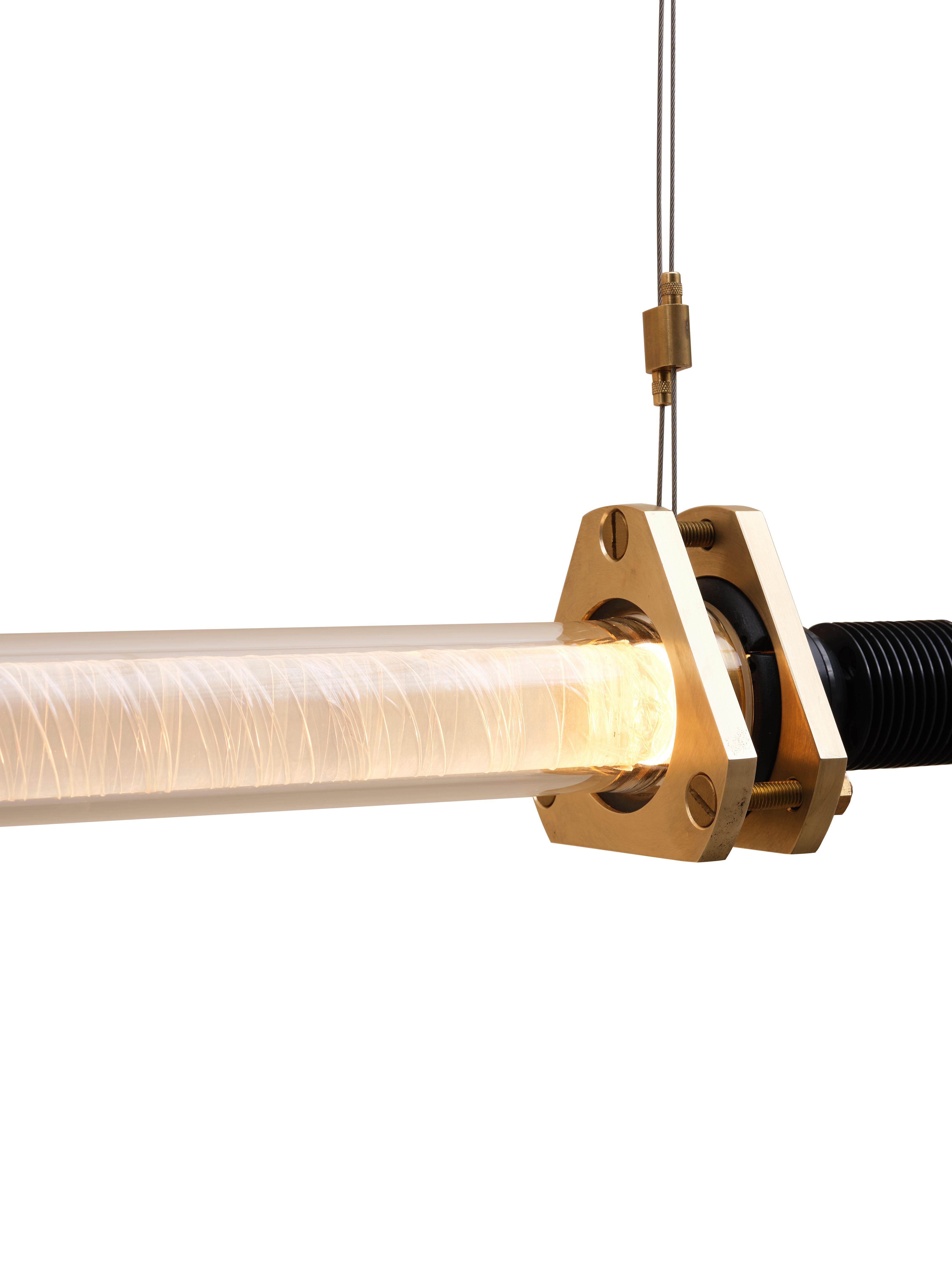 Tube S Light, 2022

Evolving Nita’s ongoing exploration of light, the Tube suspension light showcases Borosilicate glass tubes typically found in heavy industrial chemical plants. Each conceals a transparent, curved PMMA rod wrapped in cellophane