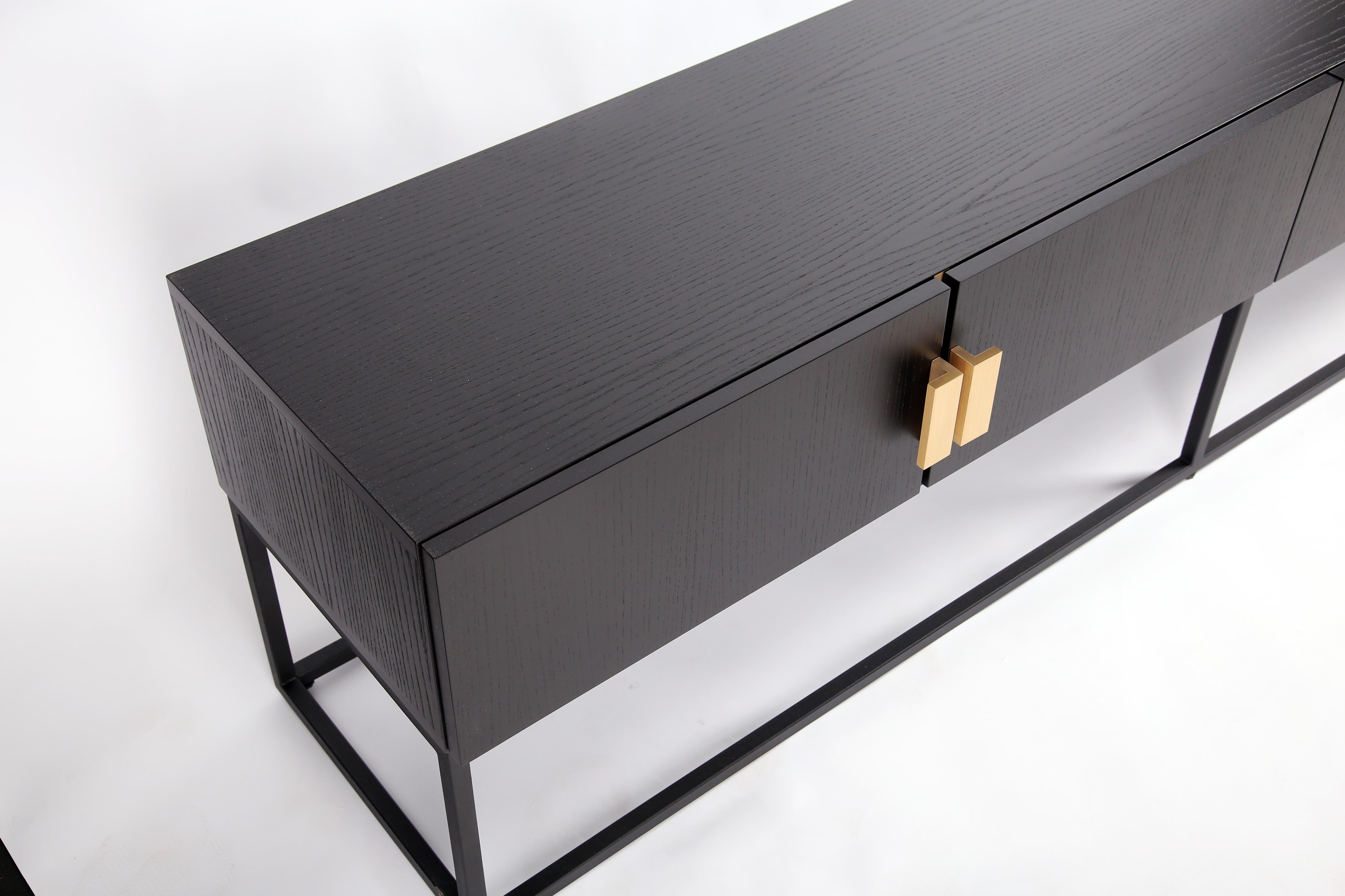 Perfect for any home, the Norse console provides ample amounts of storage in style. With a sleek and sophisticated design, the chic Norse has a gorgeous, black ash veneer that beautifully contrasts with its brushed gold handles and black steel legs.