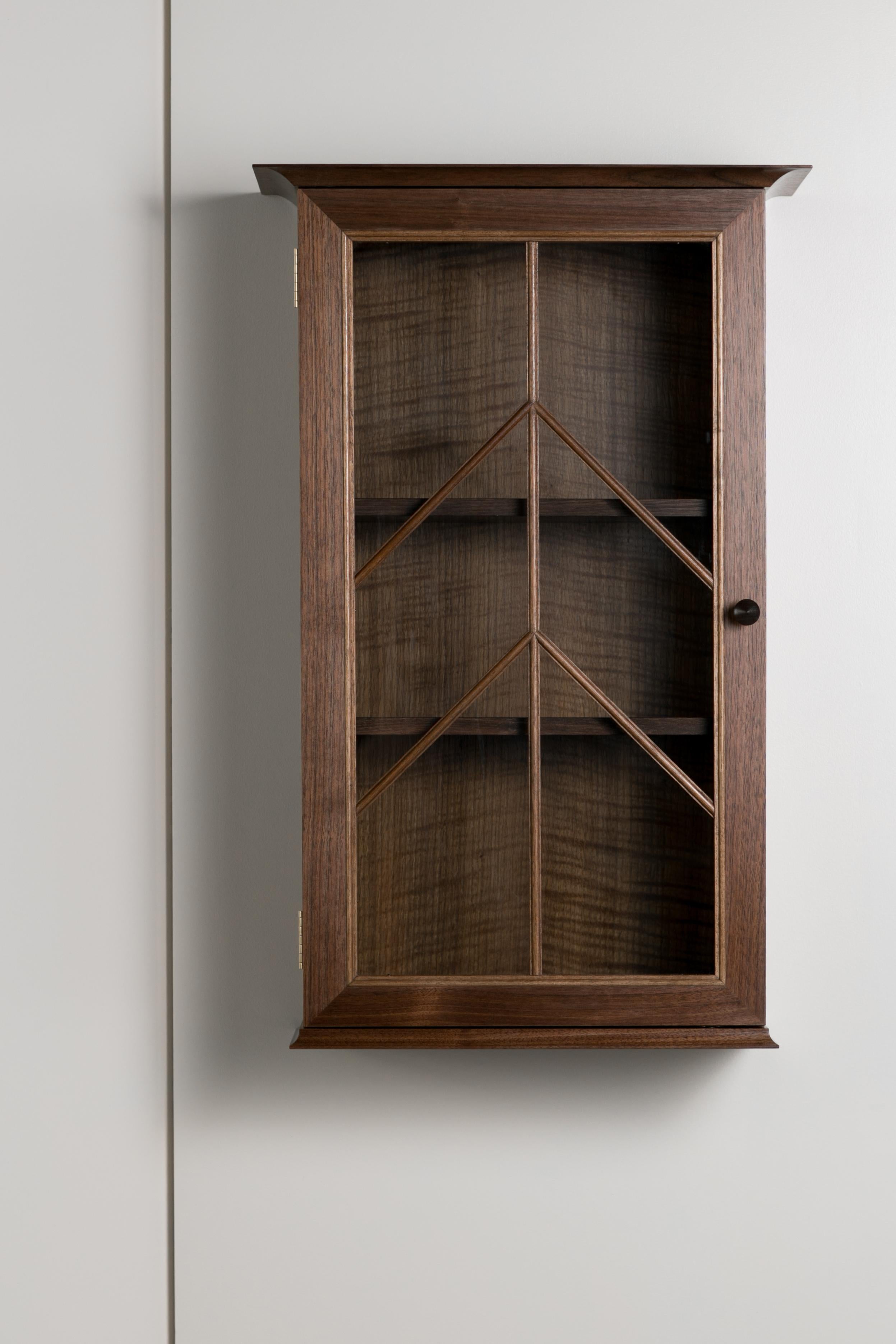 The North end wall cabinet is clean, contemporary piece with traditional elements including a molding pattern unique to Meredith Hart furniture over the glass door. Deep enough to hold wine and liquor bottles and glasses but versatile enough to hold