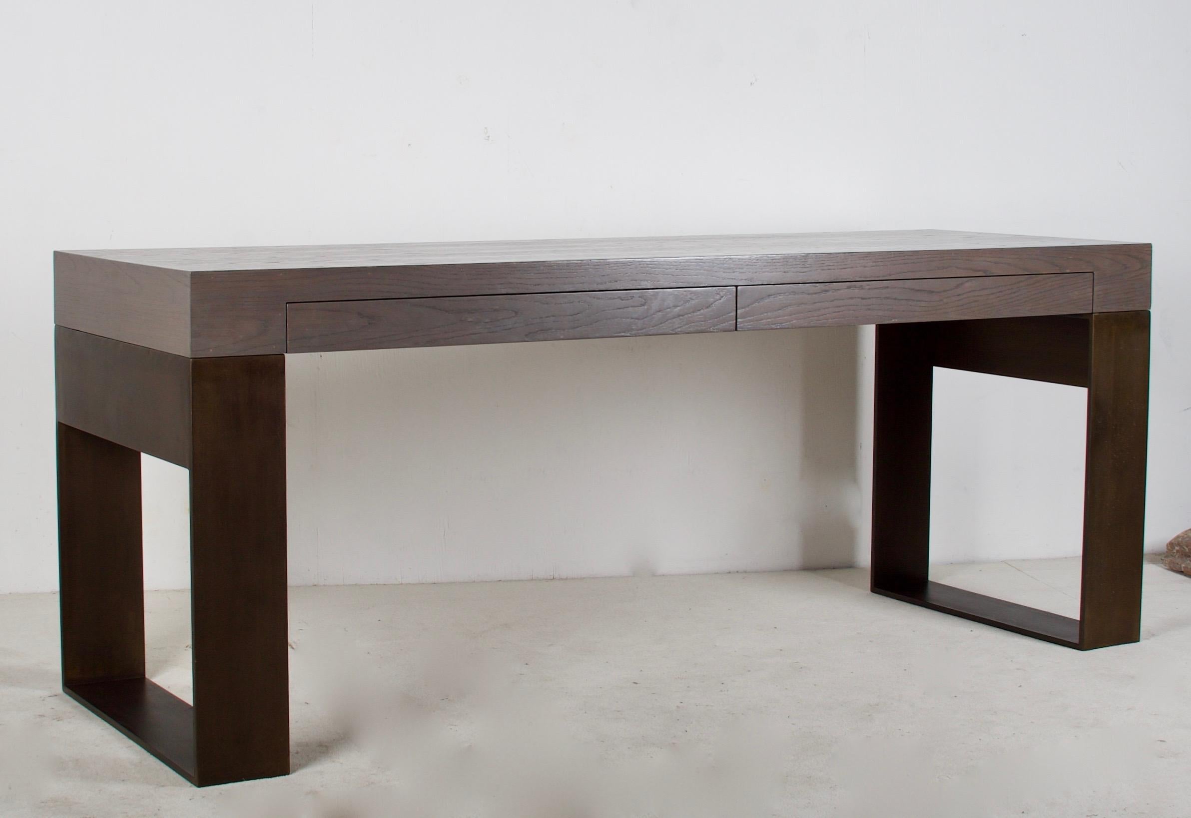 A strong and somewhat masculine desk or console table, custom
fabricated in cerused oak with a metal base, finished in a faux bronze
finish. The drawers are of a somewhat shallow nature, deep enough
for pencils etc. 
The solid oak is finished in