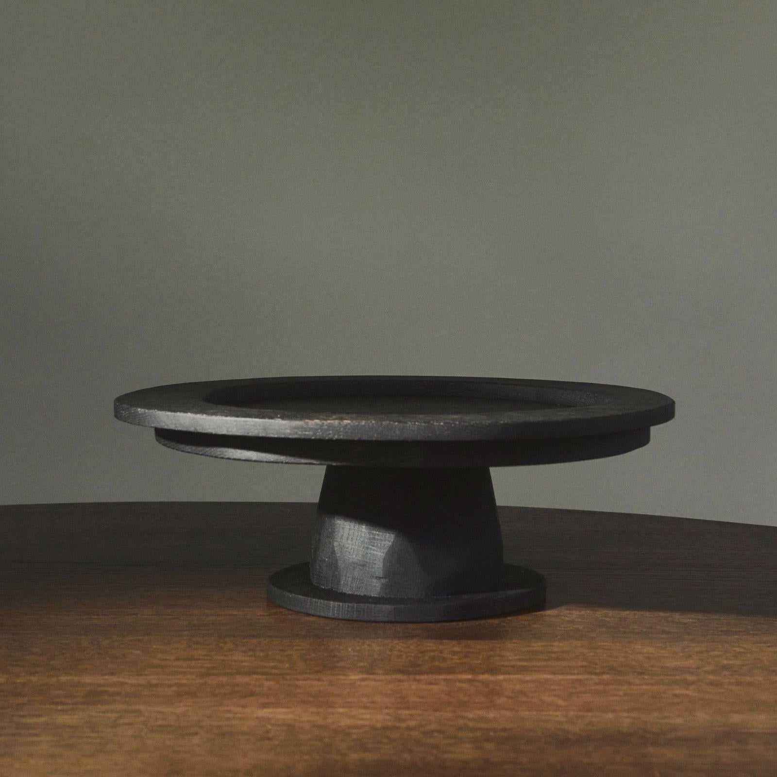 C + J Oak Pedestal Plate by Fora Projects 
Designed by Christian + Jade

Material: Oak wood
Color: Black brown
Brown surface treatment with non-toxic hardwax oil

Dimensions: (Large) 
H. 13 - D. 35 cm 

_______________

The C + J pedestal plate was