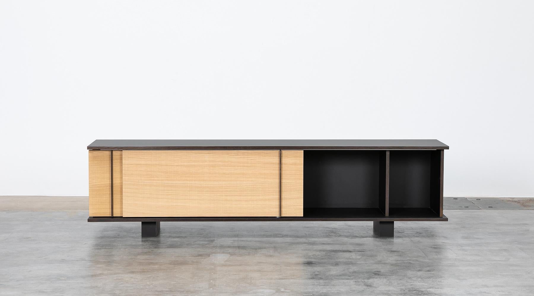 Sideboard by contemporary German artist Johannes Hock. The sliding doors of this unique piece are made of German oak wood with ebony handles, the body is made of black HPL, as well as the backside. Manufactured by Atelier Johannes Hock.