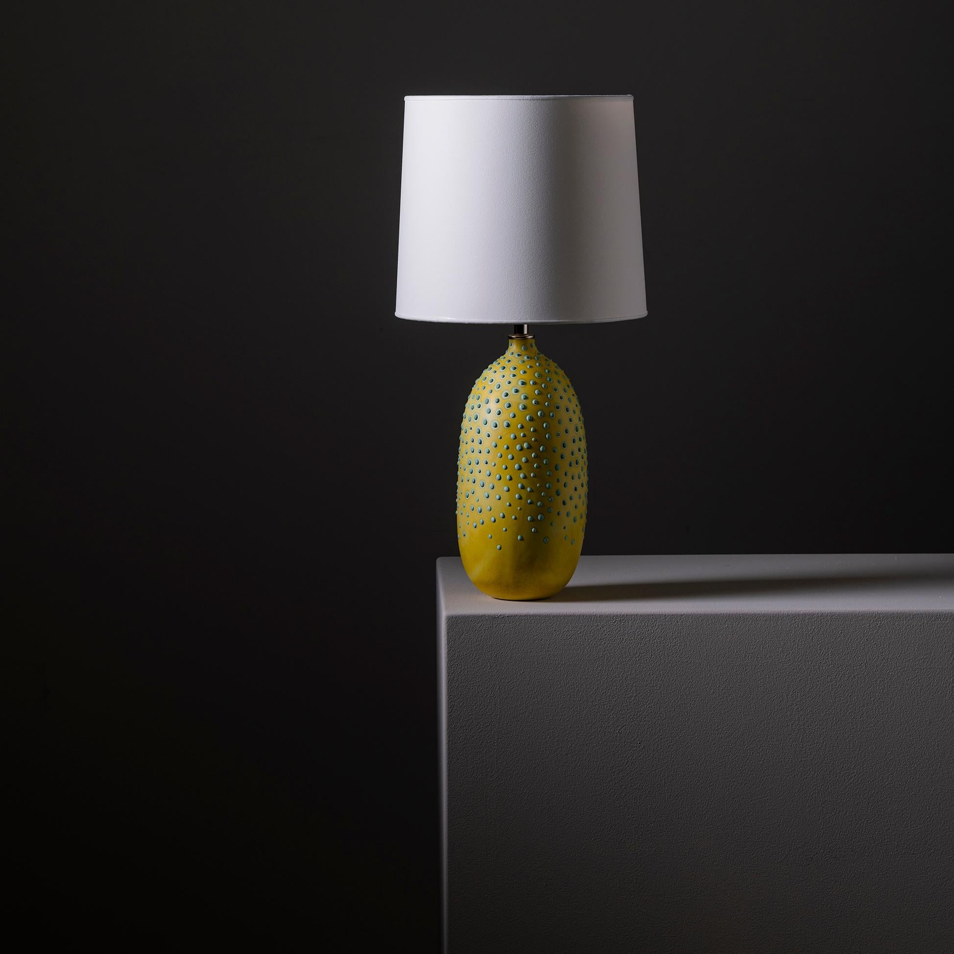 This collection is inspired by the unique galaxy of microorganisms living within each of us. We created a technique for dying and stippling each base that evokes the nature of microbes as they grow and colonize.

The base of each lamp is hand-cast