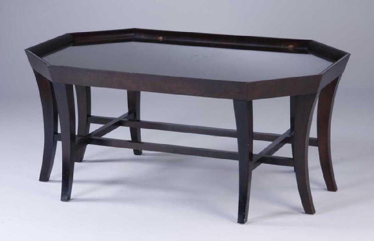 An unusual octagonal coffee table with the top inset with burled wood veneer and fitted with protective glass, raised on eight square sabre legs joined by a double H-shaped stretcher. Clean, Classic lines incorporating the unusual details of burled