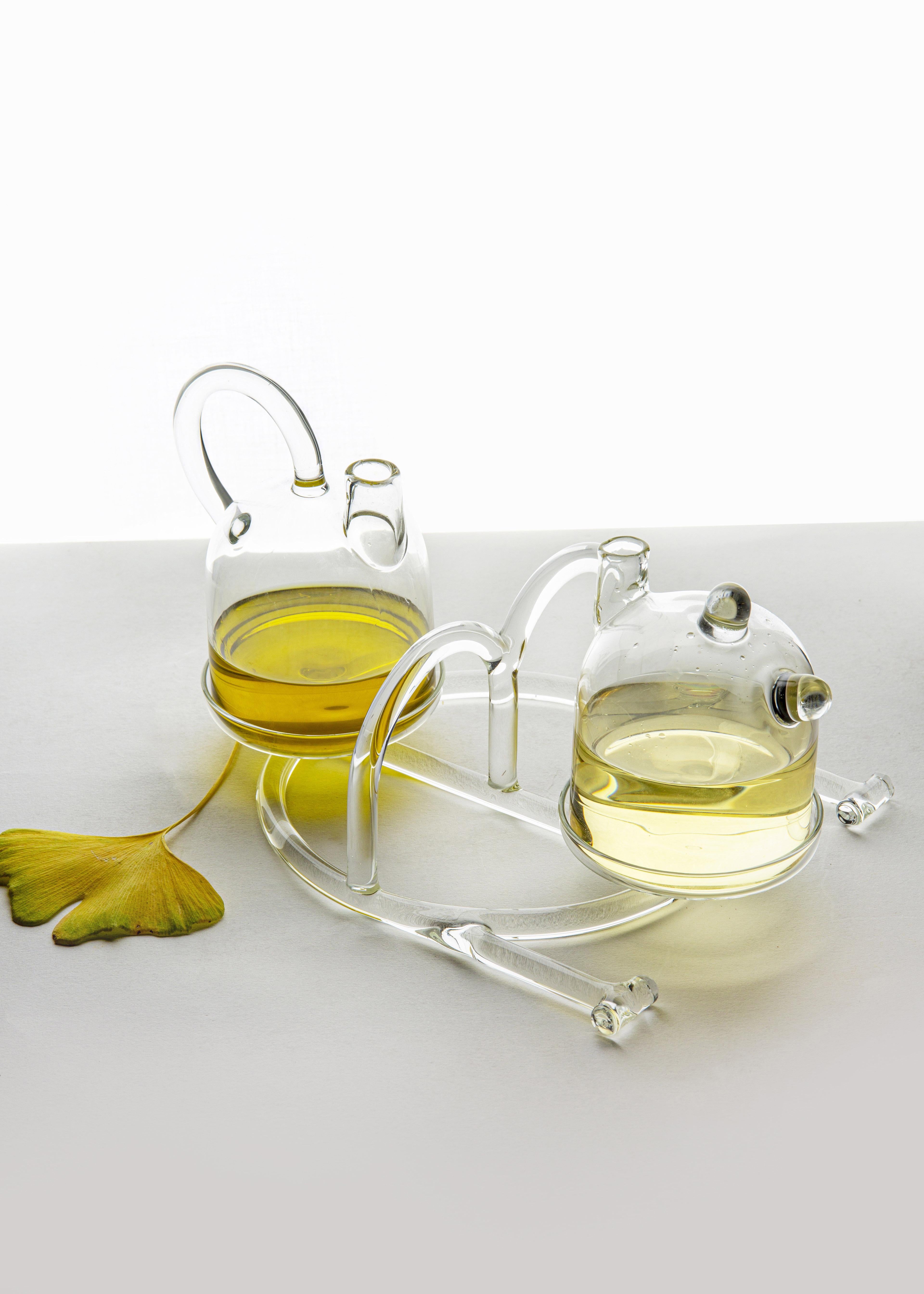Oil & vinegar from SiO2 Tableware collection 

Two small cruets suitable for holding condiments such as Oil and Vinegar. The base with
its large handle allows you too easily carry the pair of cruets. 
Part of the SiO2 tableware collection, it
