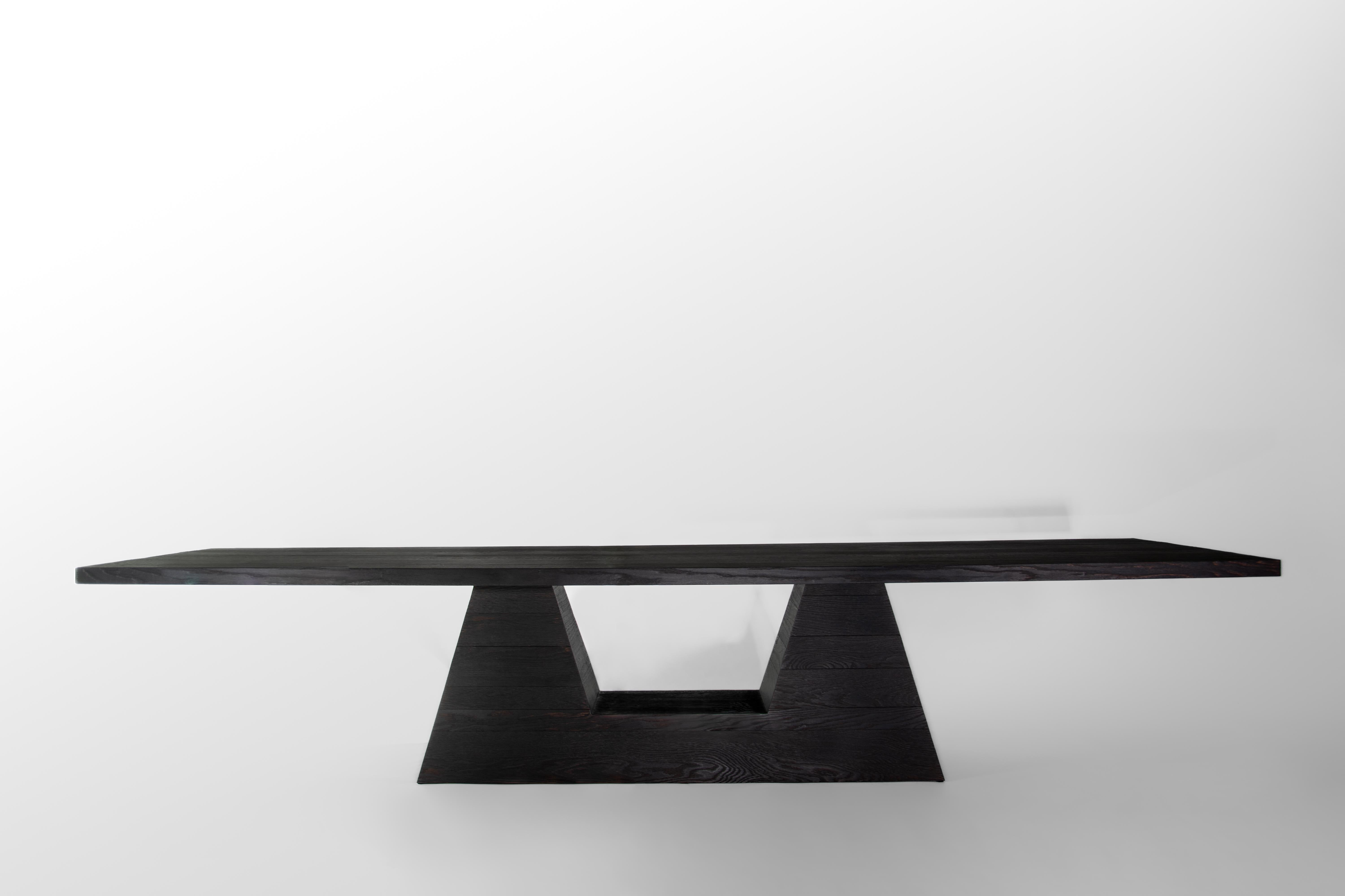 OKA Dining Table by German contemporary design studio Eichkorn. 
Material: Burnt Oak
Standard size: H.75 x 380 x 115 cm - Customizations are possible

The minimalist design of our 