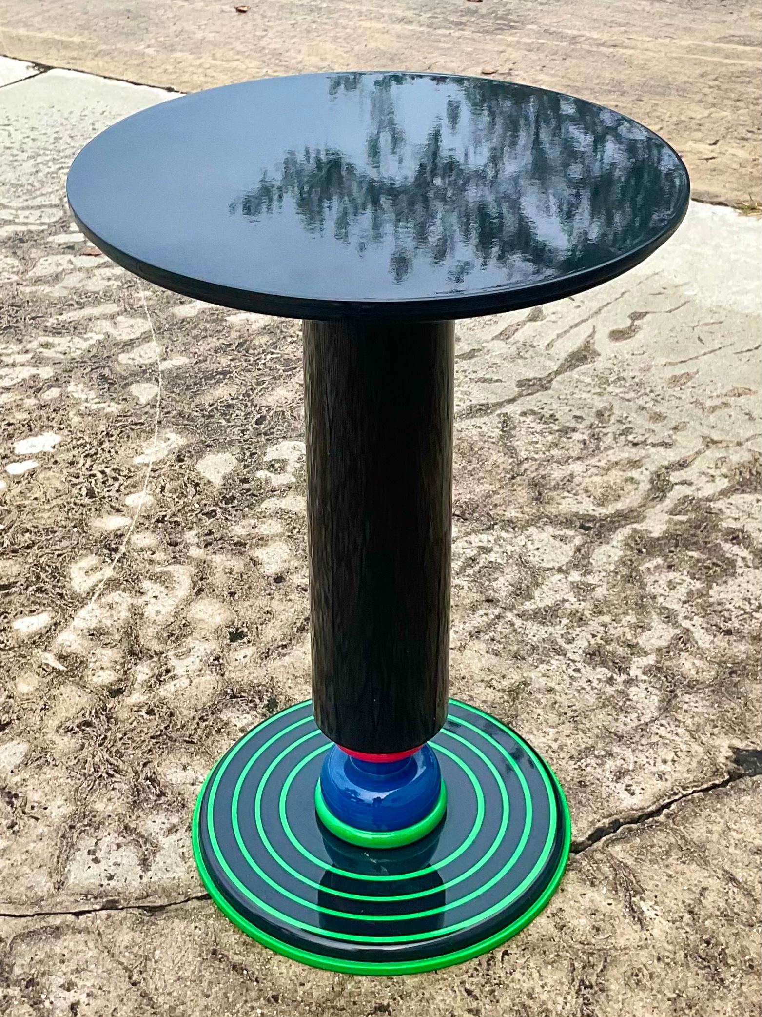 Incredible vintage Olivier Villatte drinks table. Beautiful high gloss black lacquered body with a chic acid green series if stripes on the bottom. Perfect to add that flash of color and drama to any decor. Acquired from a Palm Beach estate.