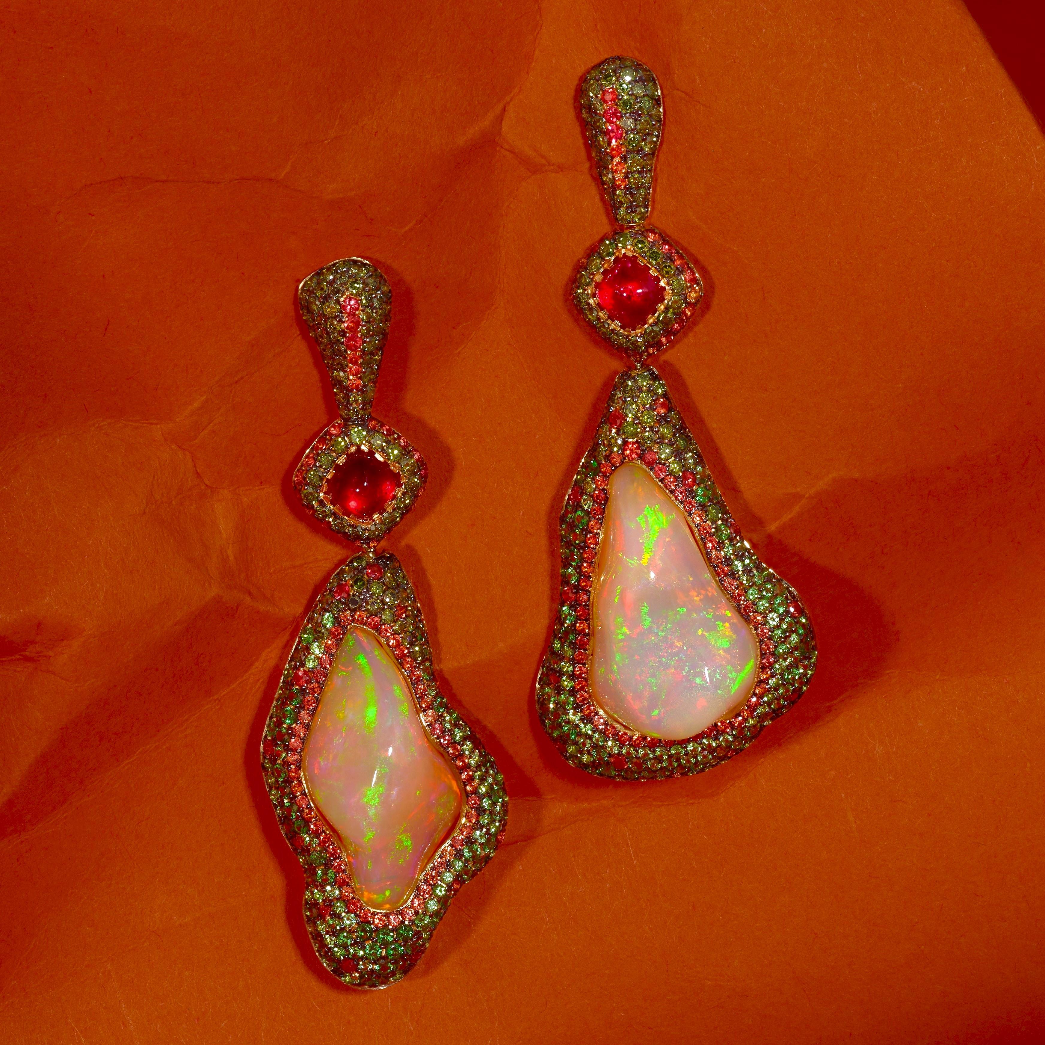 Contemporary Drop Earrings made by Rosior in Portugal made in yellow gold and set with:
- 2 white opals weighing 16,17 ct;
- 2 sugarloaf cut red spinels weighing 1,58 ct;
- 216 tsavorites weighing 1,50 ct;
- 179 orange sapphires weighing 1,41 ct;
-