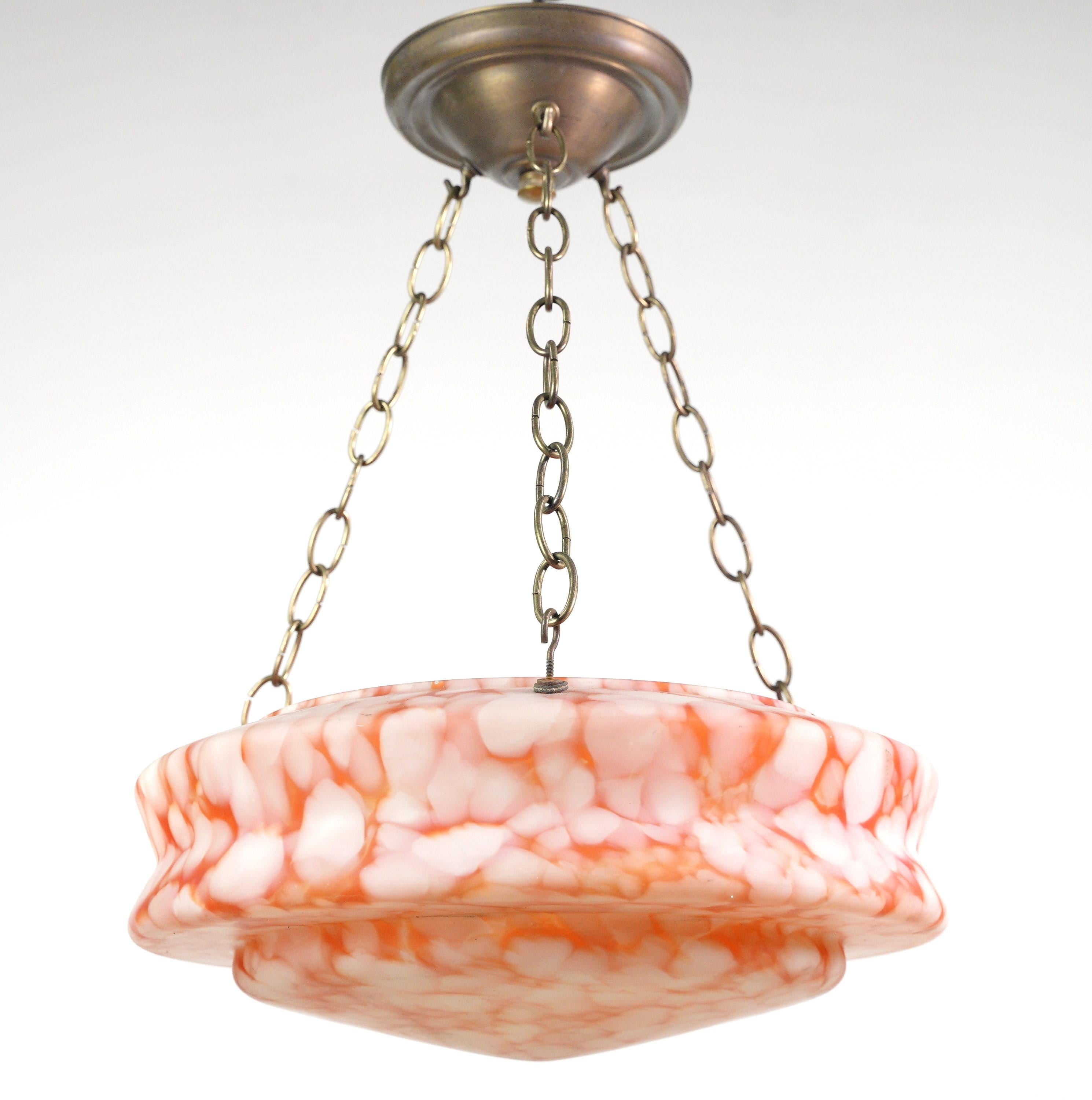 Contemporary orange & white glass and brass chain dish pendant light combines retro charm with modern aesthetics, featuring a marbled orange and white glass dish suspended by a brass chain, creating a unique and eye catching lighting element. Three