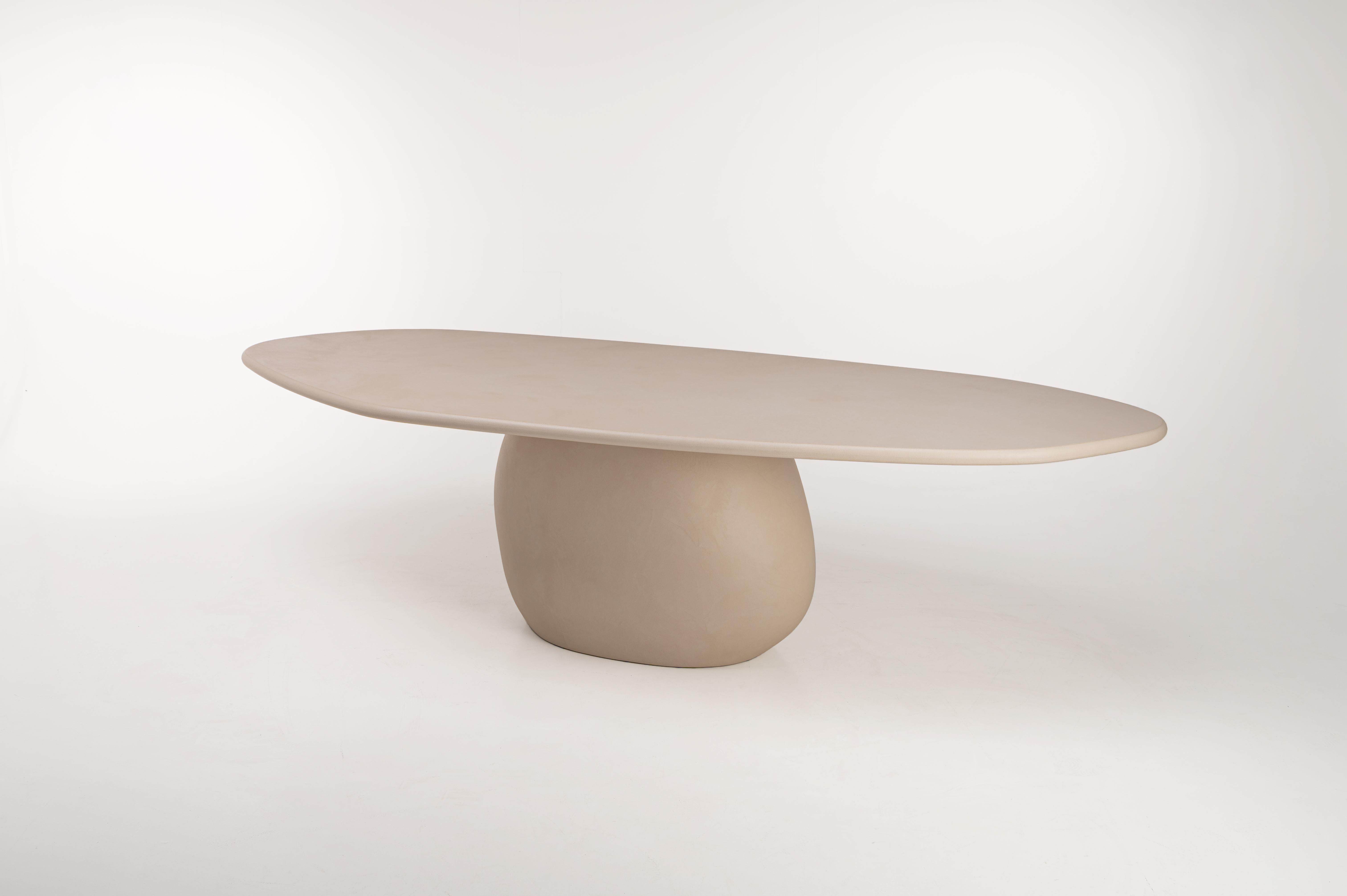 Contemporary Belgian design. Organic shaped table top with a rock shaped base. Unique handmade natural plaster table with a textured and earthy character. Stain free and very easy to maintain. Unlike natural stone, the plaster surface has a very