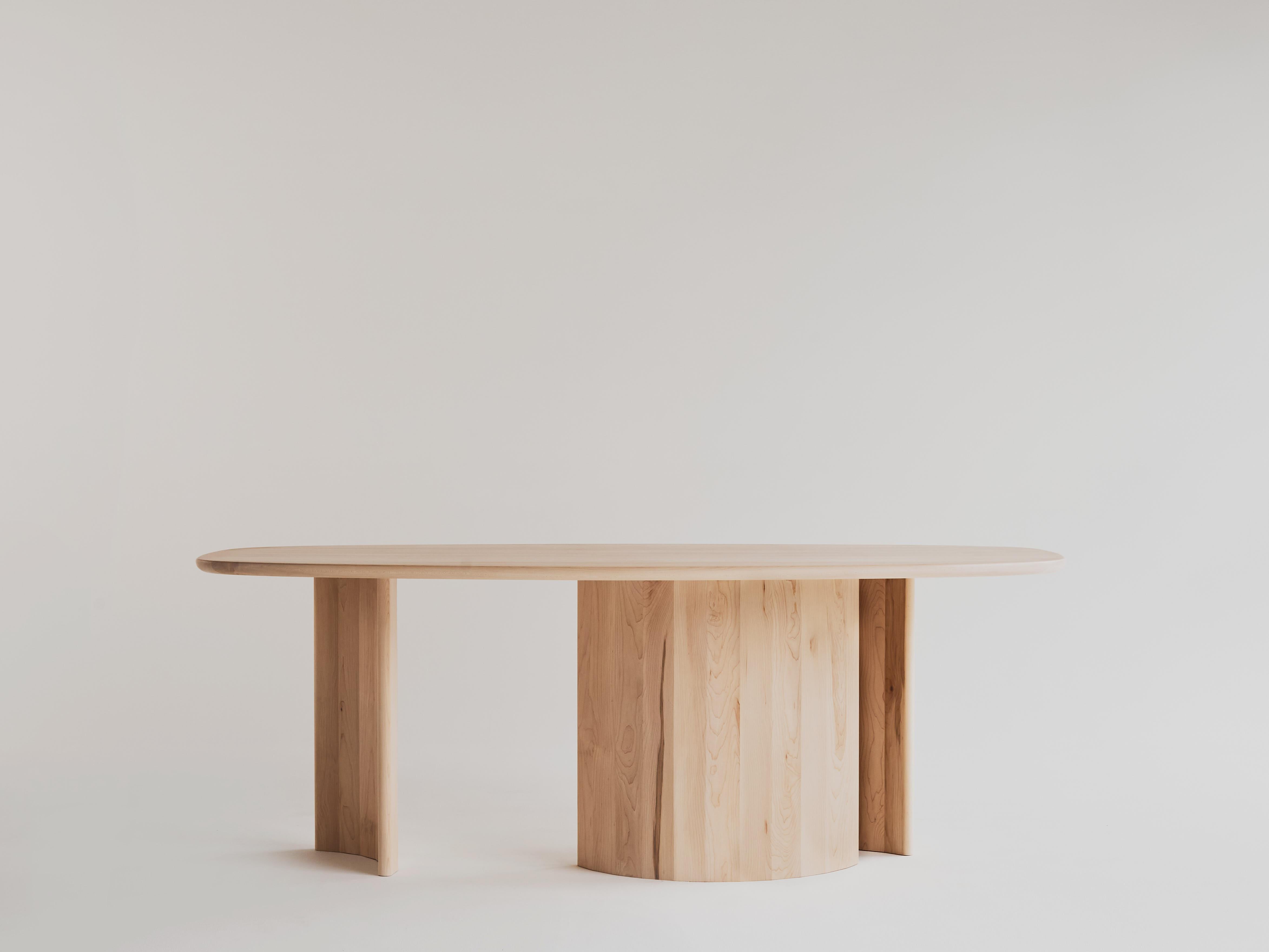 Dining table for Richard by Campagna in maple - In stock.

This sculptural, contemporary wooden dining table features a free flowing, organic top and faceted, arc-shaped legs. The interaction of the three uniquely curved legs creates moments of