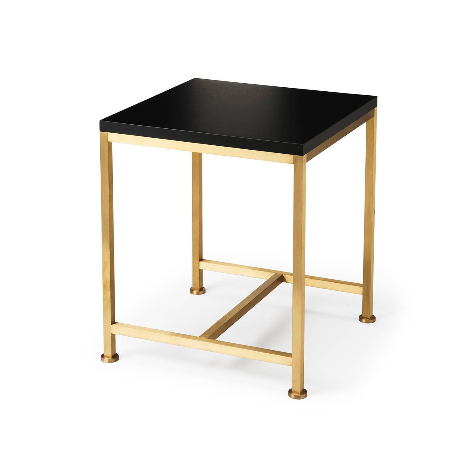 The Orichal range is perfectionist in its simplicity featuring a precision engineered solid brass frame with a top in walnut. Shown here in black lacquered walnut and brushed brass. The top is made from solid and veneered timber. The brass is