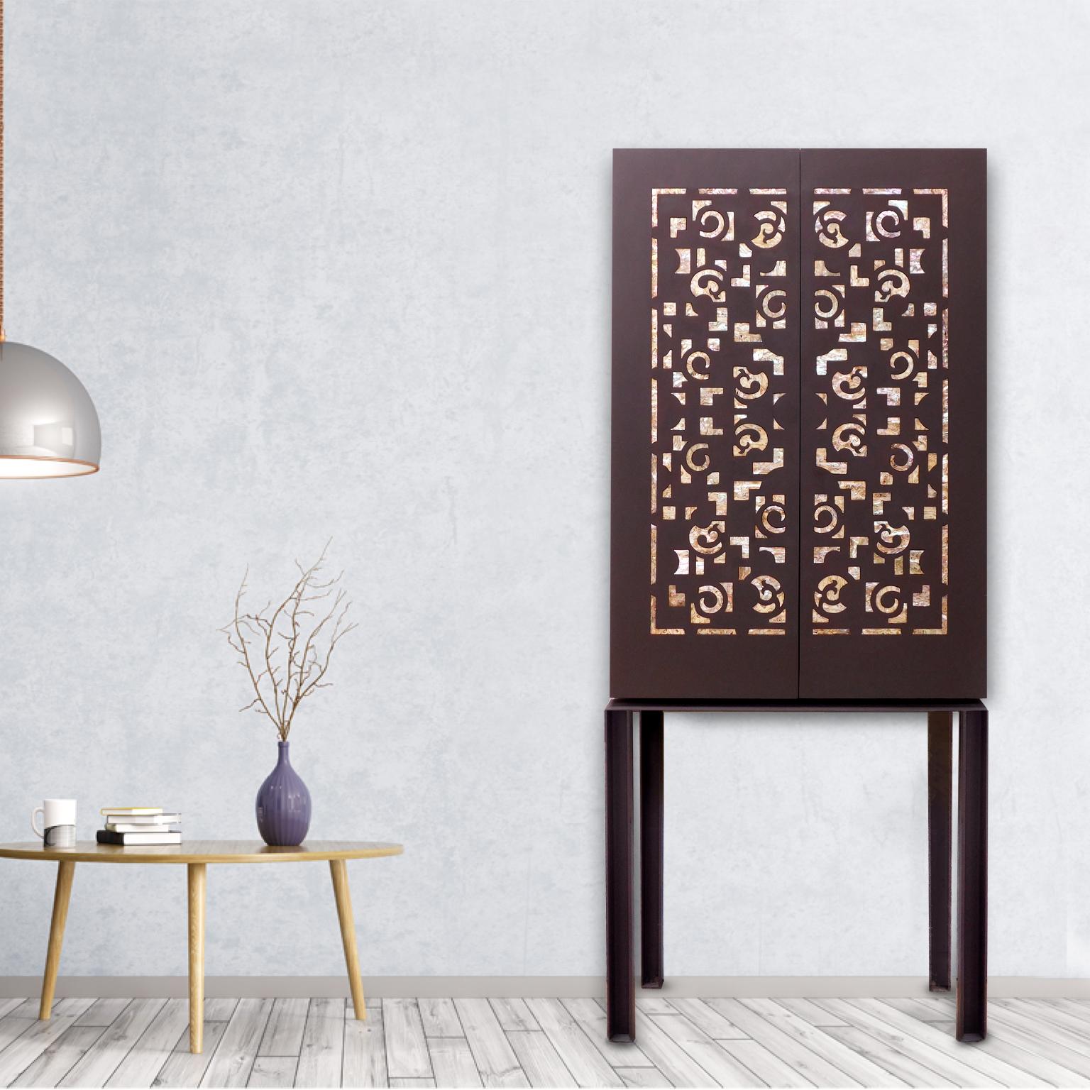 Unique contemporary styled steel cabinet with mother of pearl applications.