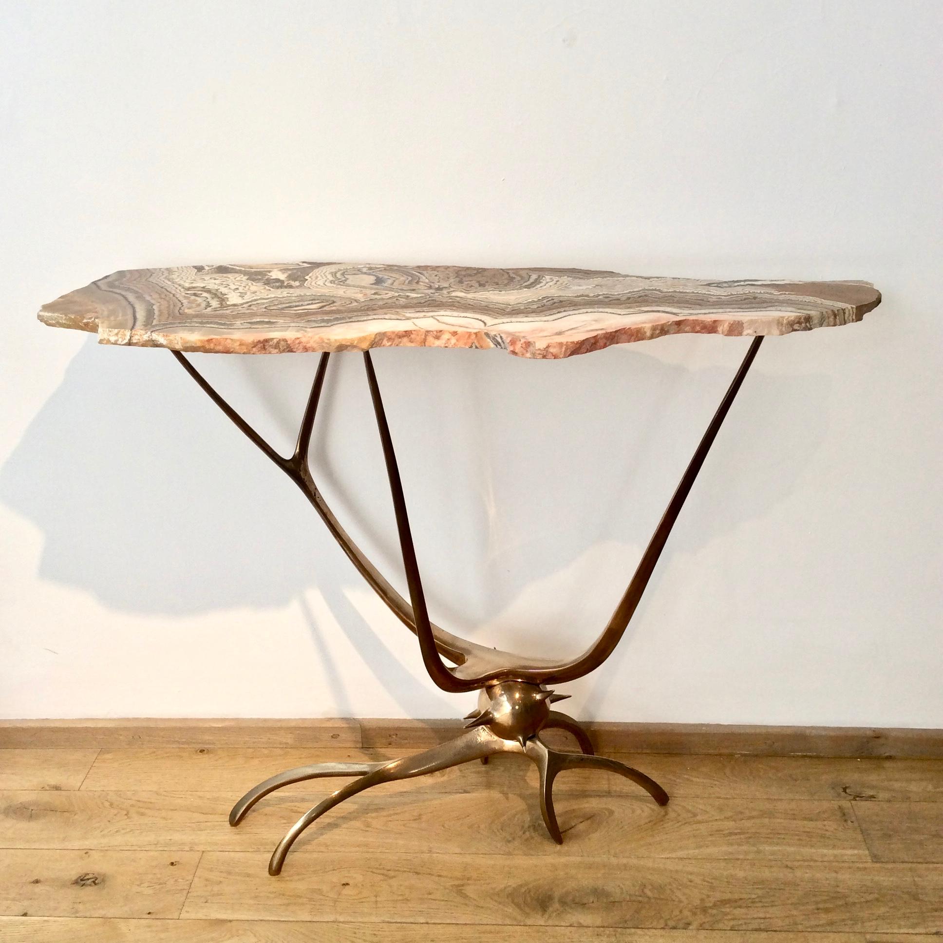 Spectacular sculptural bronze and hardstone console, the organic bronze base supports a naturally-shaped stone top with stunning veining.
Signed and dated 'Mark Brazier-Jones 2016' on base.