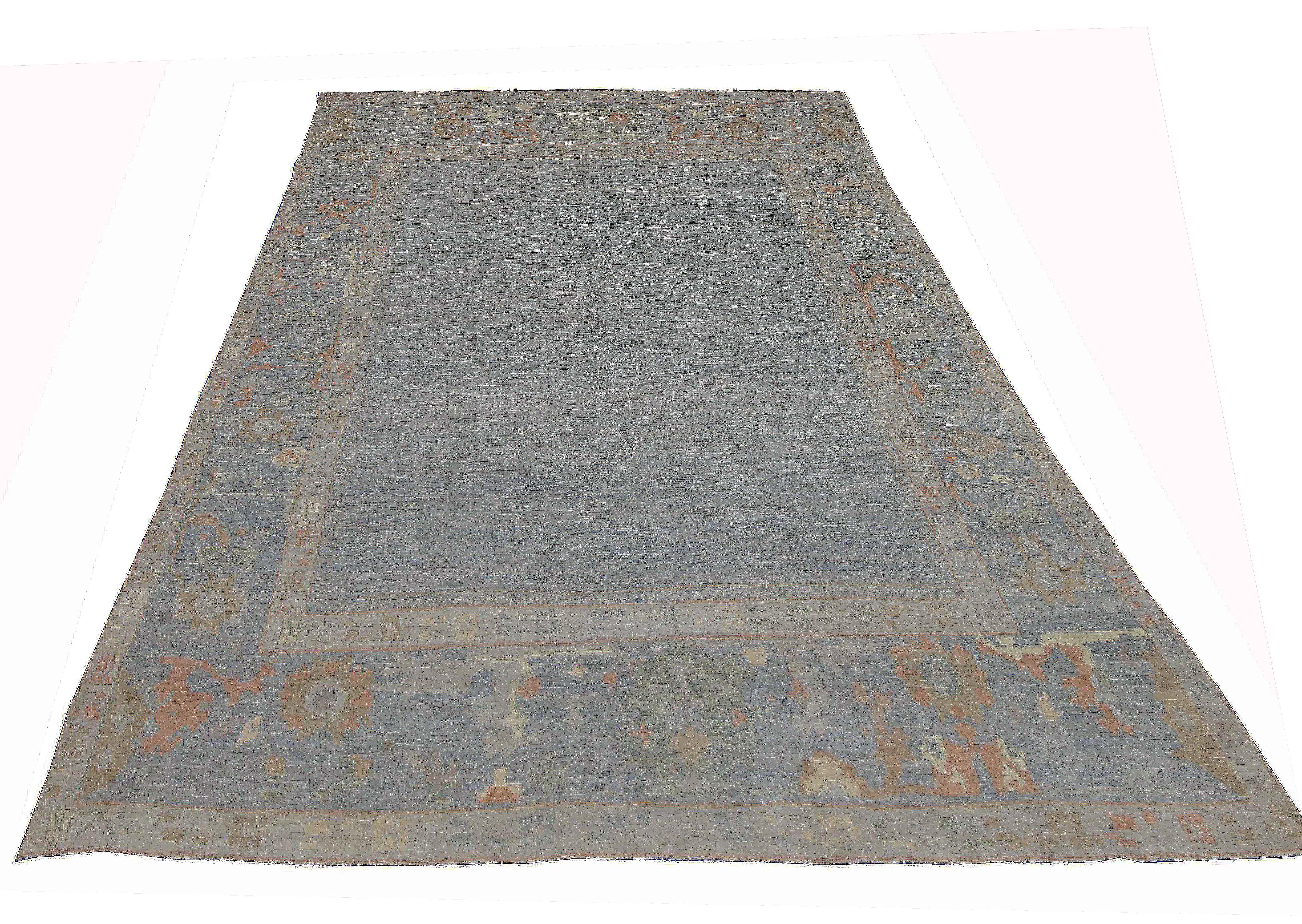 Contemporary Turkish rug made of handwoven sheep’s wool of the finest quality. It’s colored with organic vegetable dyes that are certified safe for humans and pets alike. It features a lovely gray field with rust and beige floral details closely