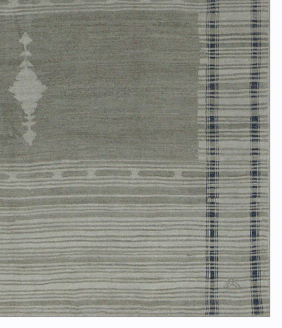 Contemporary Turkish rug made of handwoven sheep’s wool of the finest quality. It’s colored with organic vegetable dyes that are certified safe for humans and pets alike. It features a lovely gray field with black and beige stripes accented by