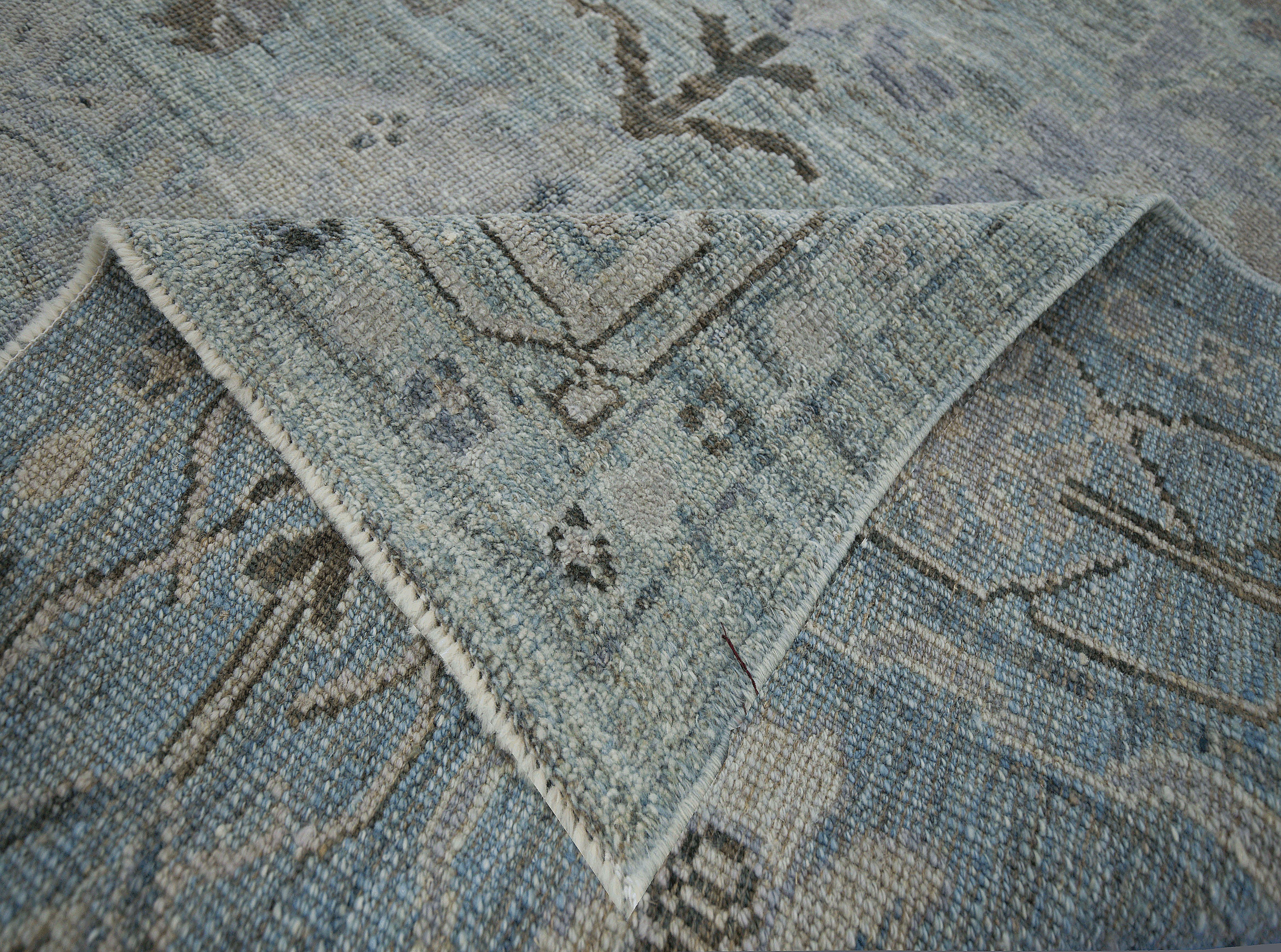  Contemporary Turkish rug made of handwoven sheep’s wool of the finest quality. It’s colored with organic vegetable dyes that are certified safe for humans and pets alike. It features a lovely bluish green field with floral medallion details in