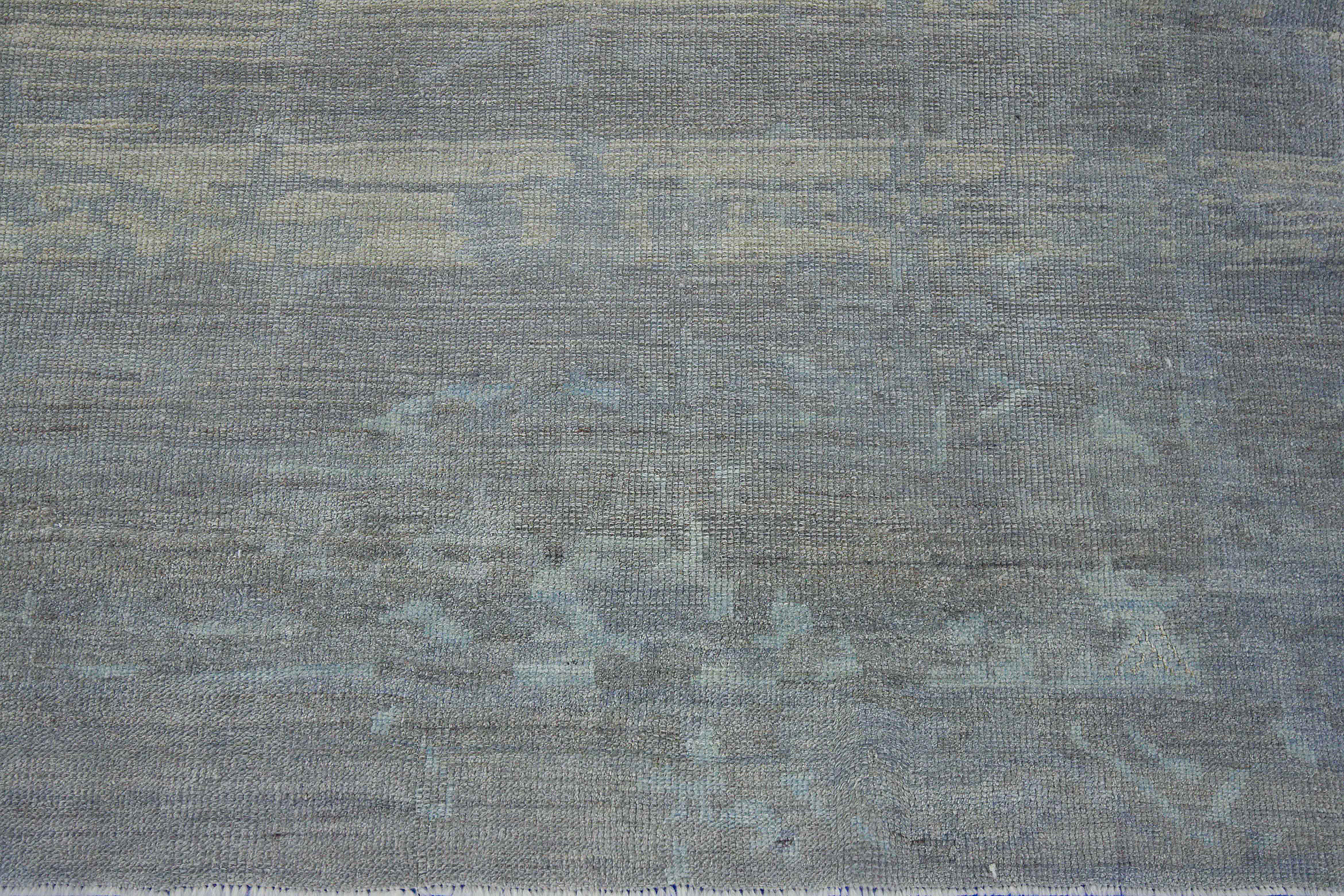 Modern Turkish rug made of handwoven sheep’s wool of the finest quality. It’s colored with organic vegetable dyes that are certified safe for humans and pets alike. It features a lovely beige field with floral details in blue and gray commonly