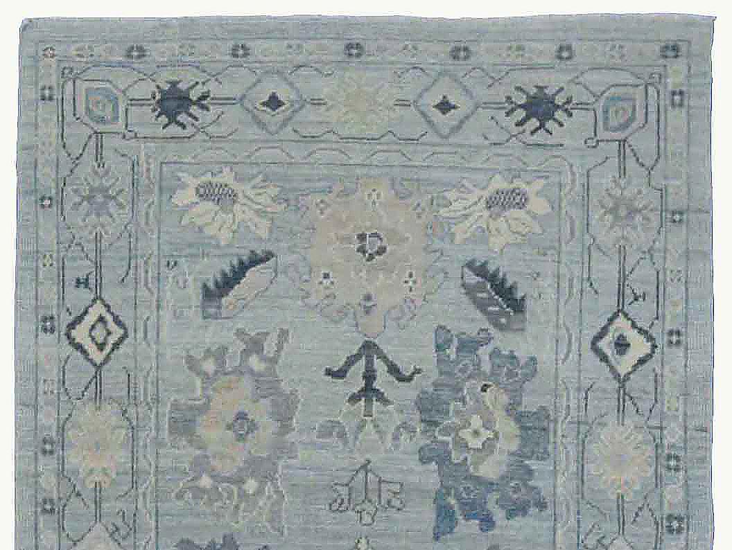 Contemporary Turkish runner rug made of handwoven sheep’s wool of the finest quality. It’s colored with organic vegetable dyes that are certified safe for humans and pets alike. It features a beautiful blue field with floral details in white, gray
