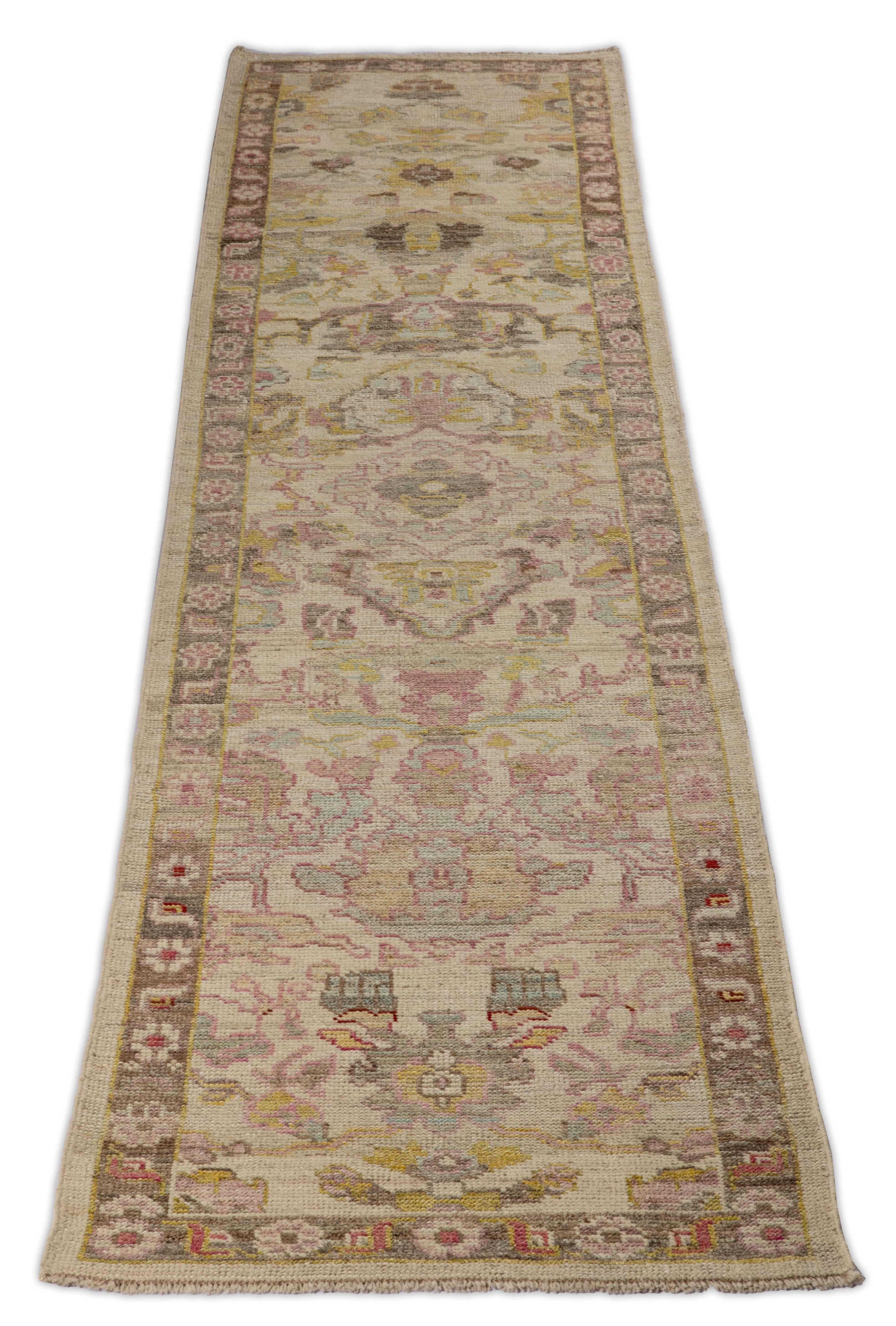 New Turkish runner rug made of handwoven sheep’s wool of the finest quality. It’s colored with organic vegetable dyes that are certified safe for humans and pets alike. It features a long, ivory field with flower details allover in brown, pink and