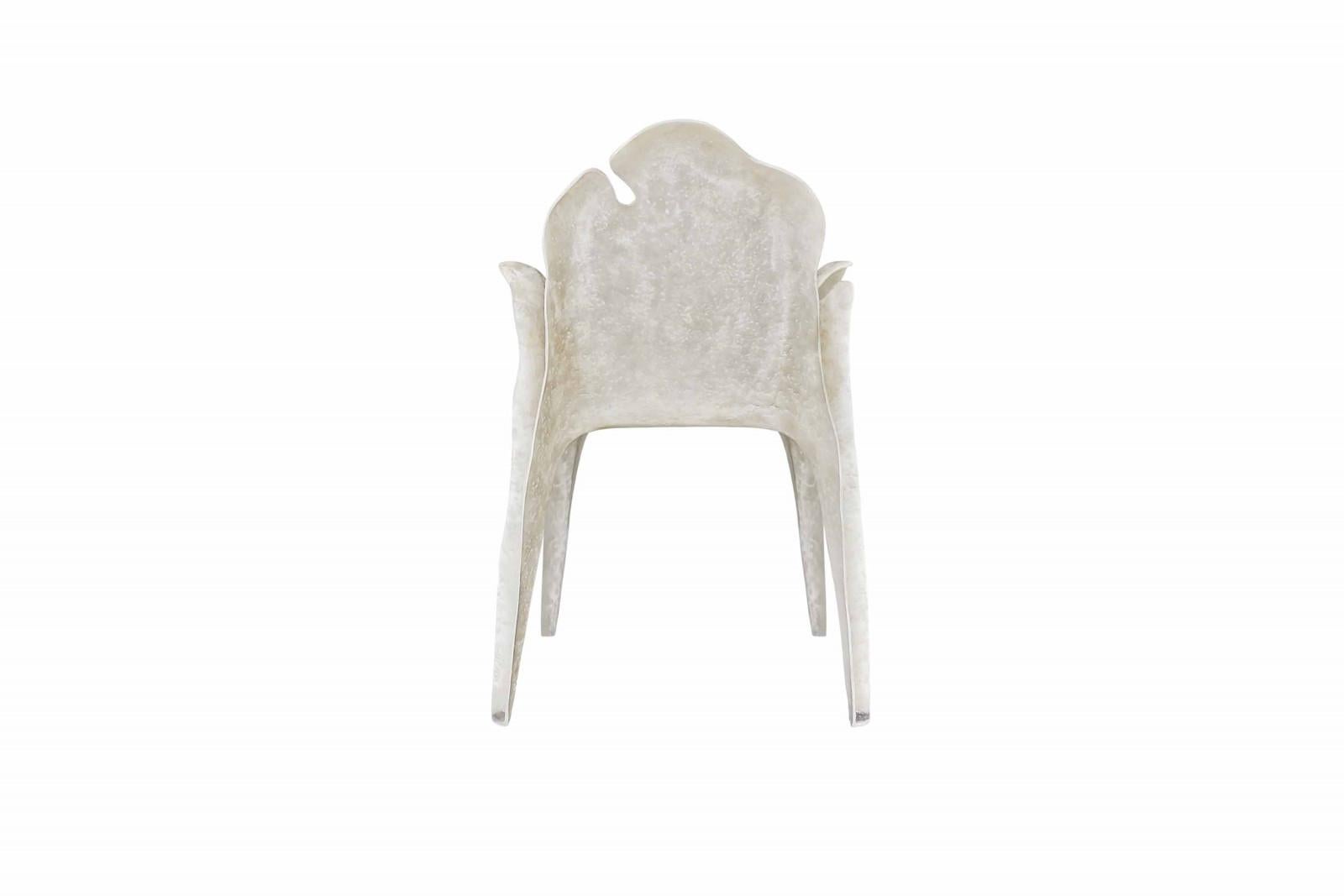 Contemporary outdoor/indoor chairs built with resin reinforced fiberglass. This highly resistant material is very durable and requires less maintenance than concrete. The chairs are then given an aged finish done by special artisans. Seat cushion
