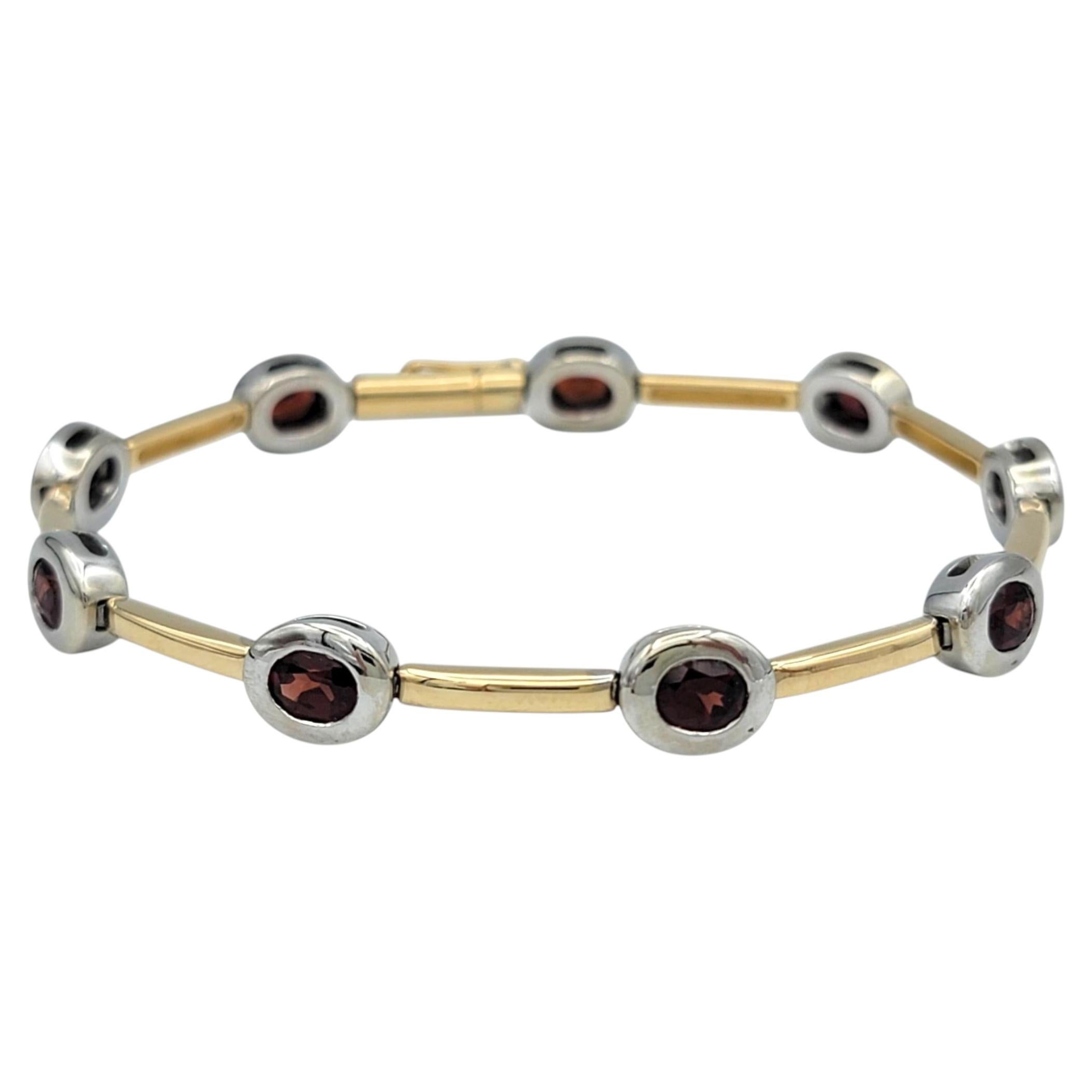 Contemporary Oval Cut Garnet Station Bracelet in Two-Tone 14 Karat Gold For Sale