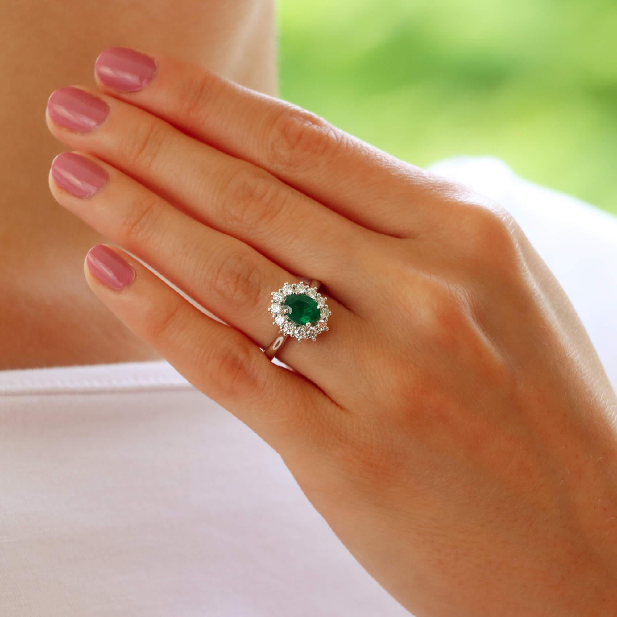 A beautiful emerald and diamond cluster ring set in platinum.

The piece is centrally set with a vibrant oval cut emerald which is four claw set in platinum. The emerald has a fantastic vibrant green colour to it and is surrounded by 12 round