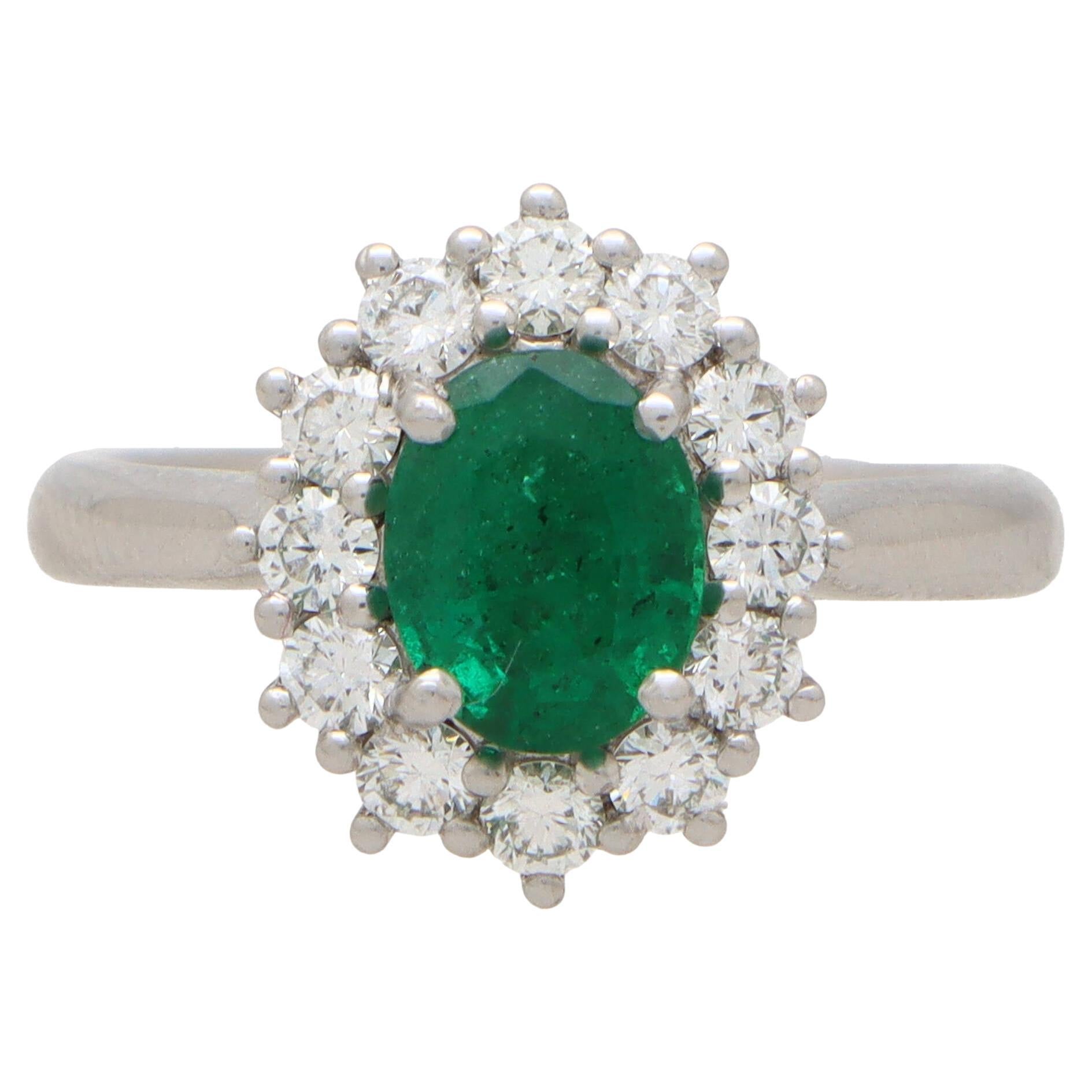 Contemporary Oval Emerald and Diamond Cluster Ring Set in Platinum For Sale