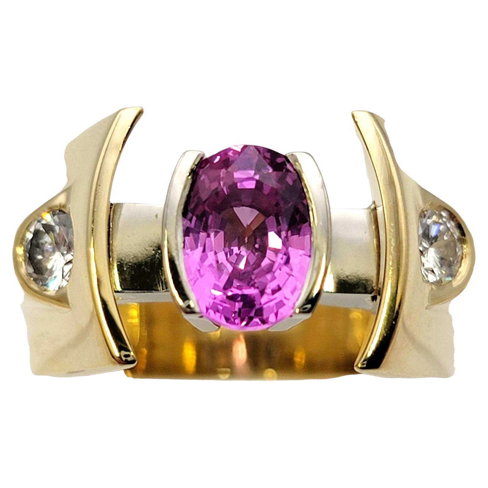 Ring size: 9.75

Ultra contemporary pink sapphire and diamond statement ring offers a bold look with a with unique design. A bright pink oval shaped sapphire sits at the very center, half bezel set in 18 karat gold. There is a significant gap on