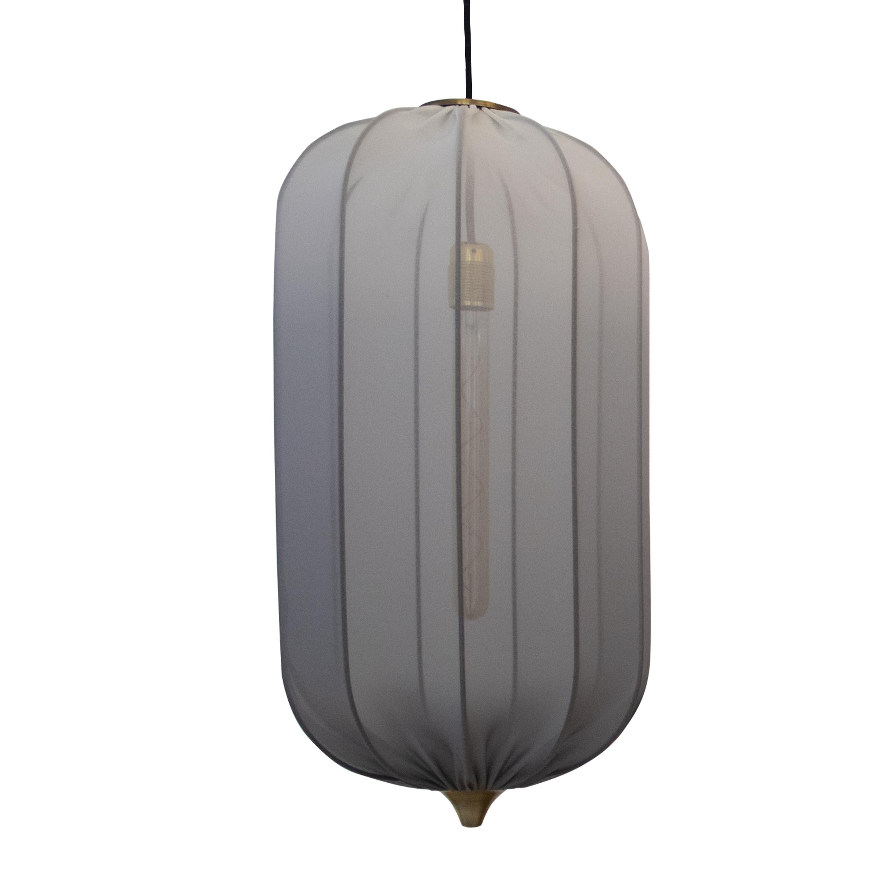 Oval Tulip-shaped ceiling lamp designed by IKB191. The lamp consists of a brass structure upholstered in faded semi-transparent gray elastane adjustable fabric, with brass cone details and a charcoal light bulb.
 