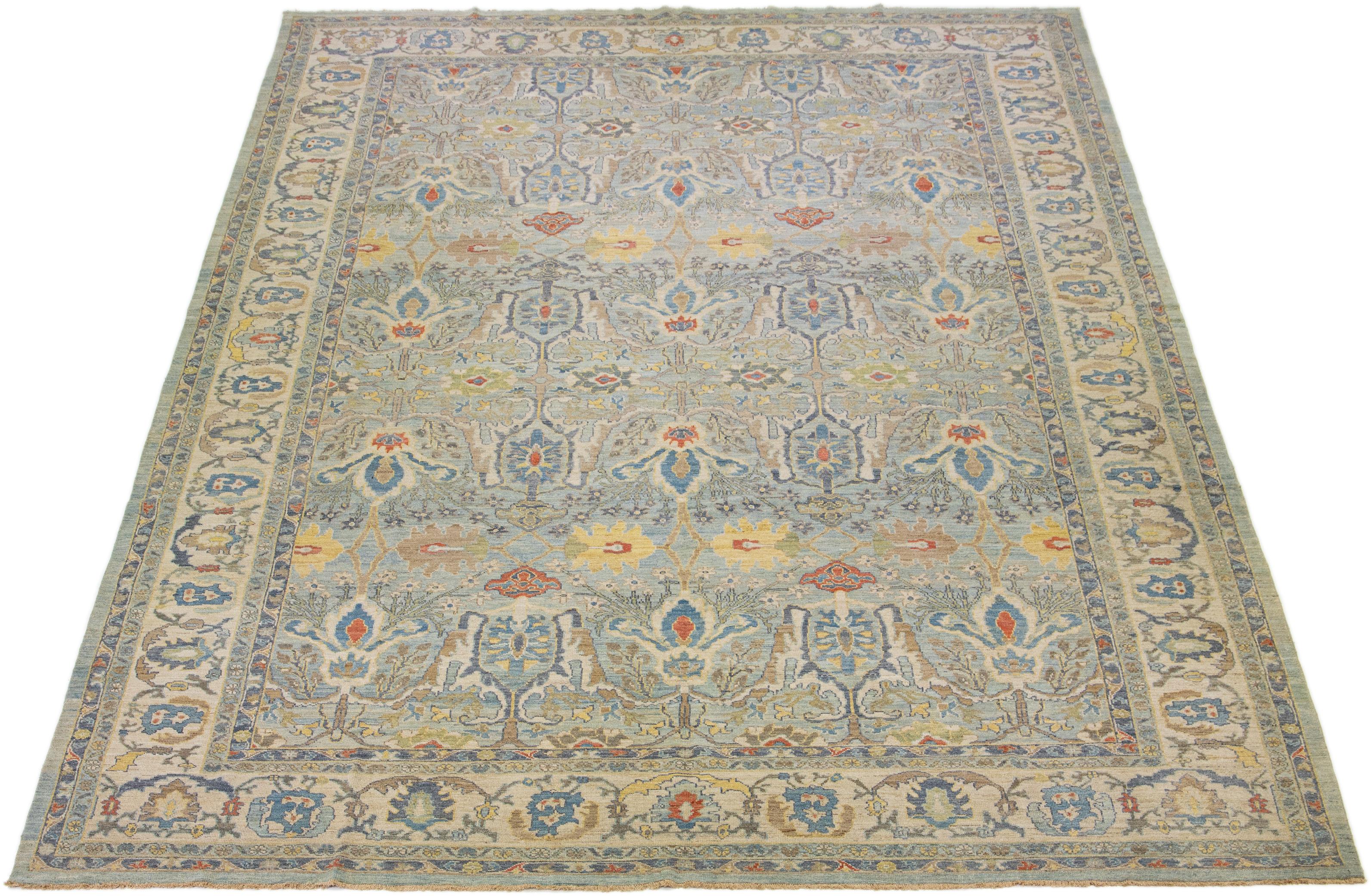 This modern reinterpretation of timeless Sultanabad design is beautifully manifested in an exquisitely hand knotted wool rug, resplendent in its striking light blue shade. An intricate beige border delineates its all-over floral embroidery,