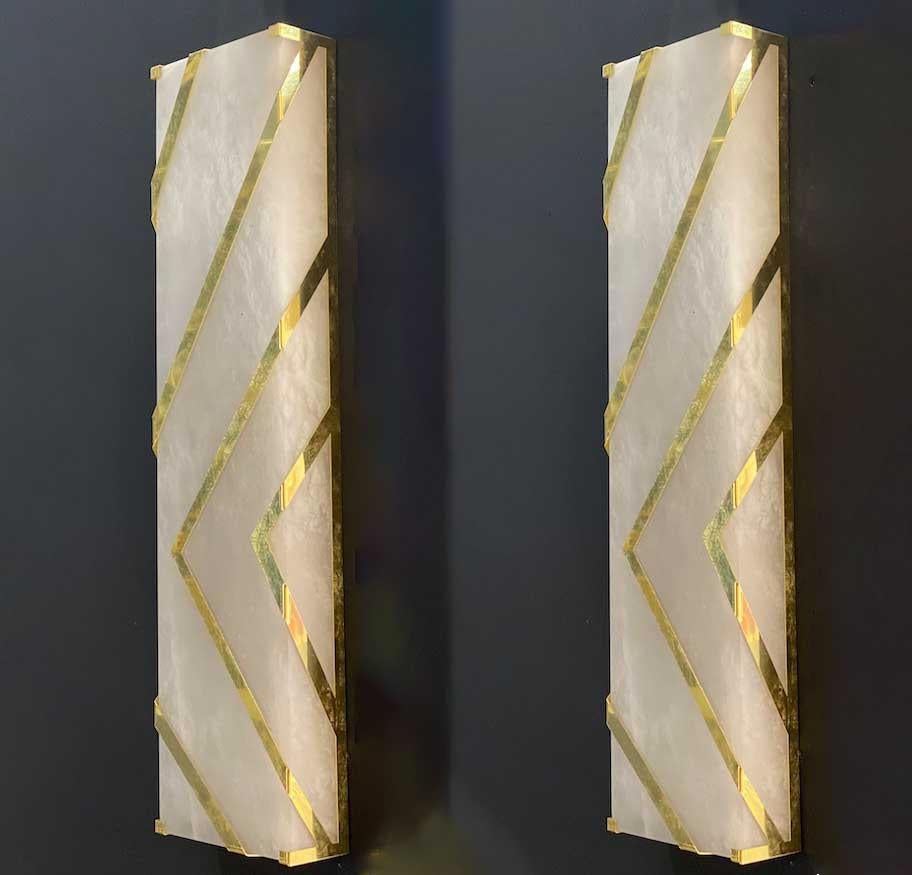 Striking contemporary Italian Alabaster marble sconces or wall lights with brass decoration. 
Exclusive production by Veneziani Arte , handmade with great skill of Italian craftsmanship.
Each with 2 E 14 light bulbs (4W)
 Price is for the pair.