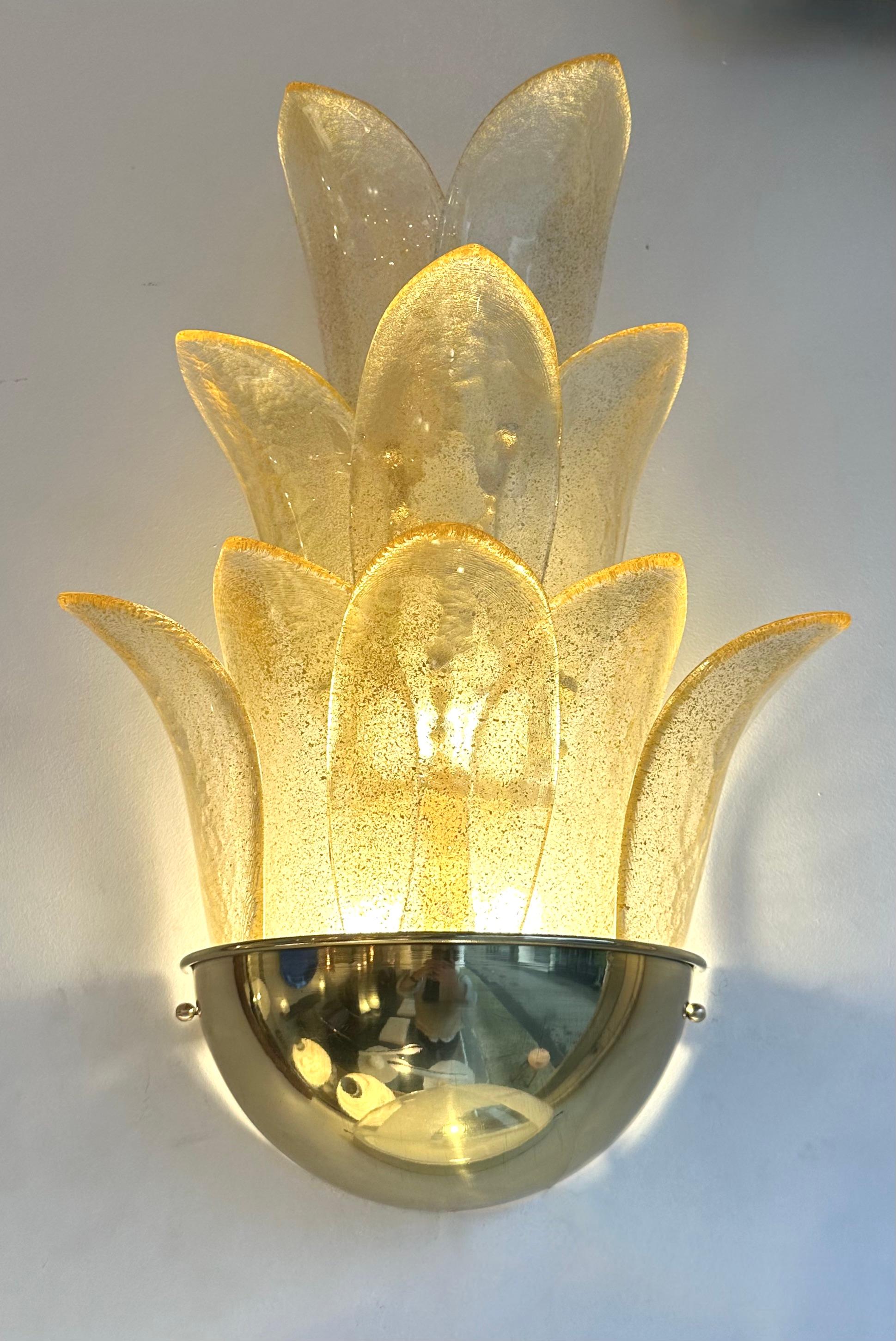 Pair of Contemporary Gilt gold powder leaf Murano glass and brass palm tree leaf wall lights lightning lamps sconces. Contemporary work from a small artisanal italian design workshop. In the mood of Mid-Century Modern, Hollywood Regency, Venini,