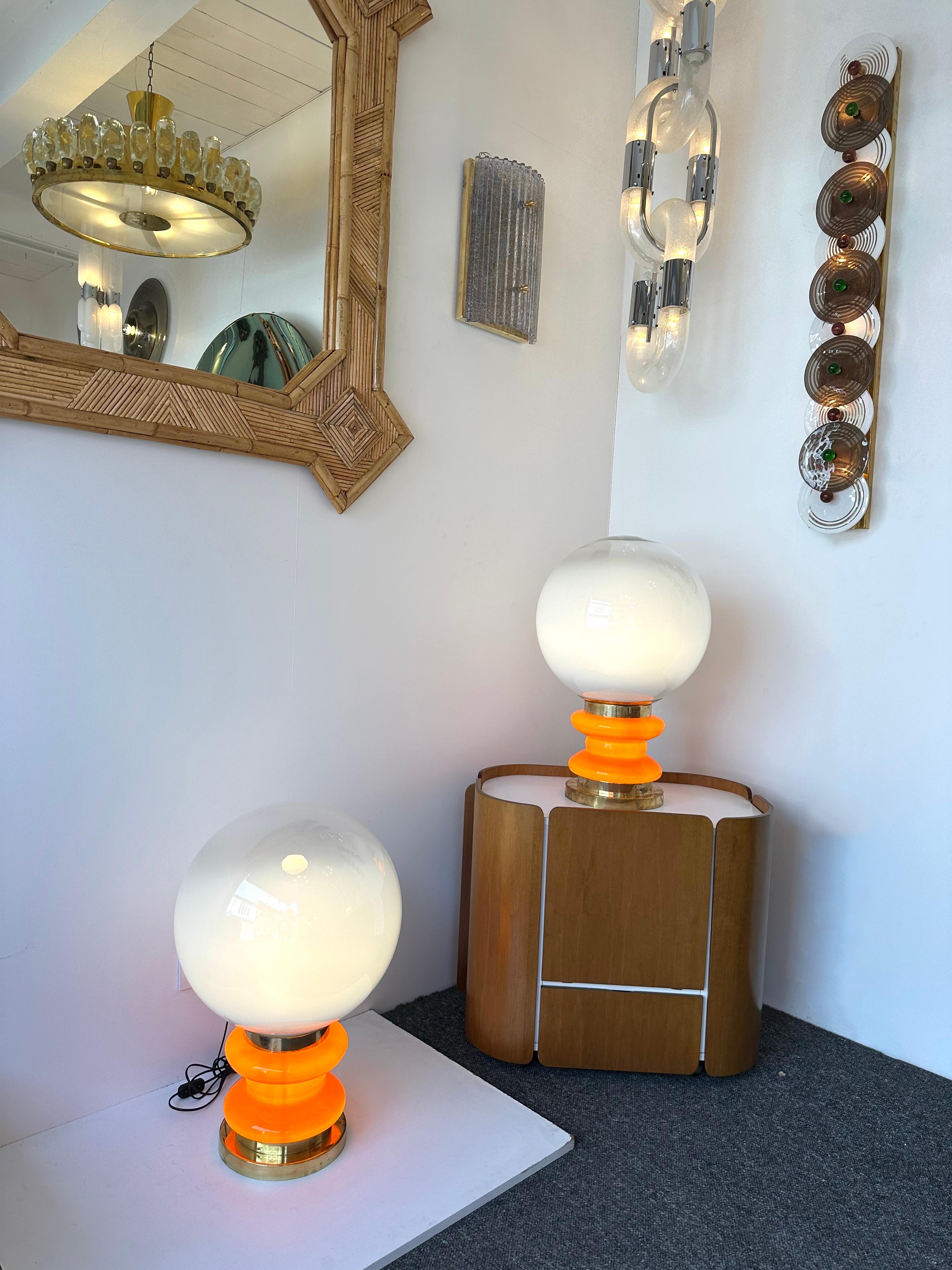 Paire de lampes de table ou de chevet à ampoule en laiton et verre de Murano orange, base d'éclairage interne, globe en verre de Murano blanc fumé. Travail contemporain d'un petit atelier artisanal de design italien, imperfections mineures dues au