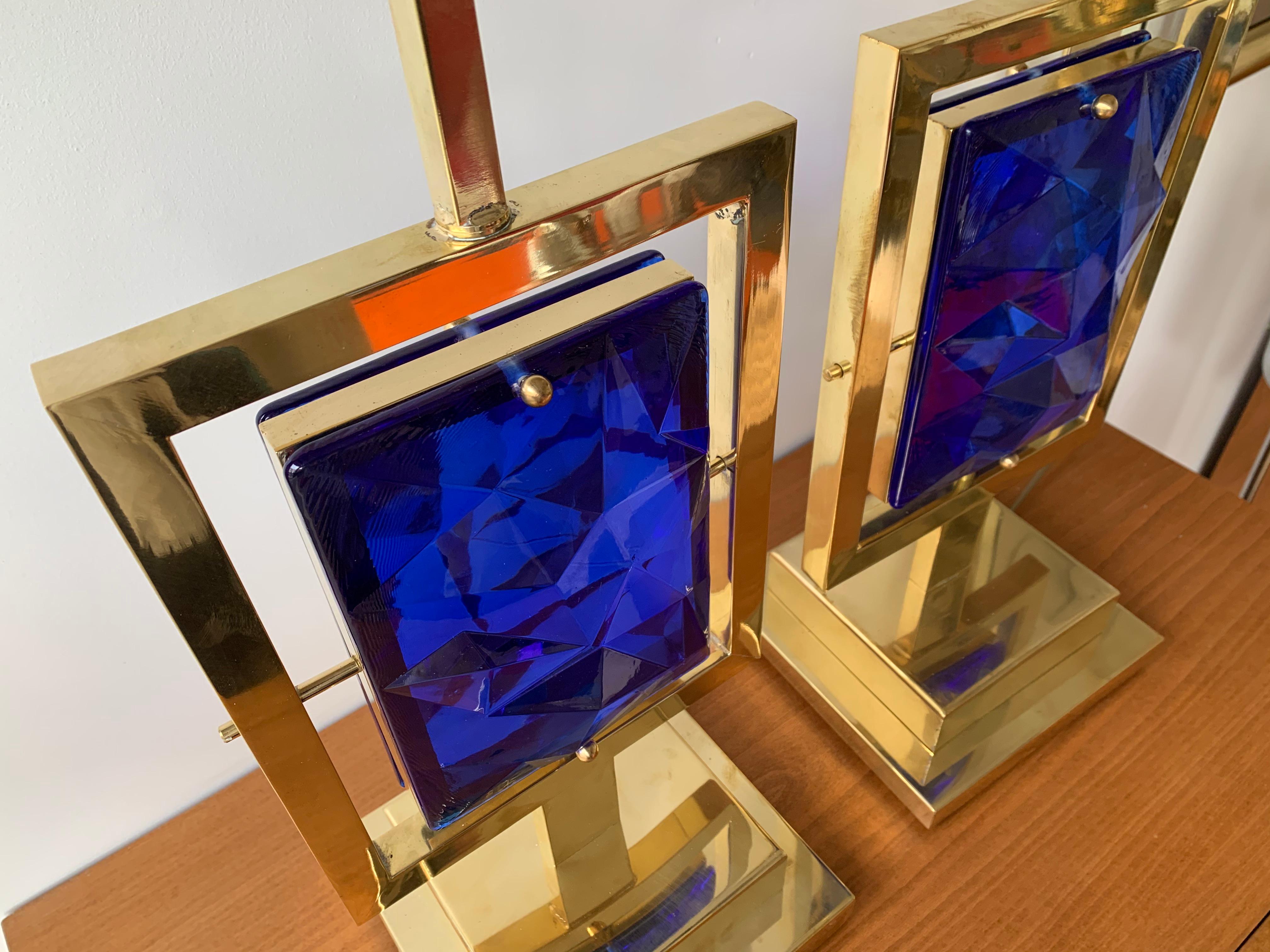 Pair of brass and faceted blue Murano glass table lamps. Contemporary work small Italian Murano workshop. 

To note: demonstration shades not included. Measurements indicated with demo shades. Height top of socket 59cms.