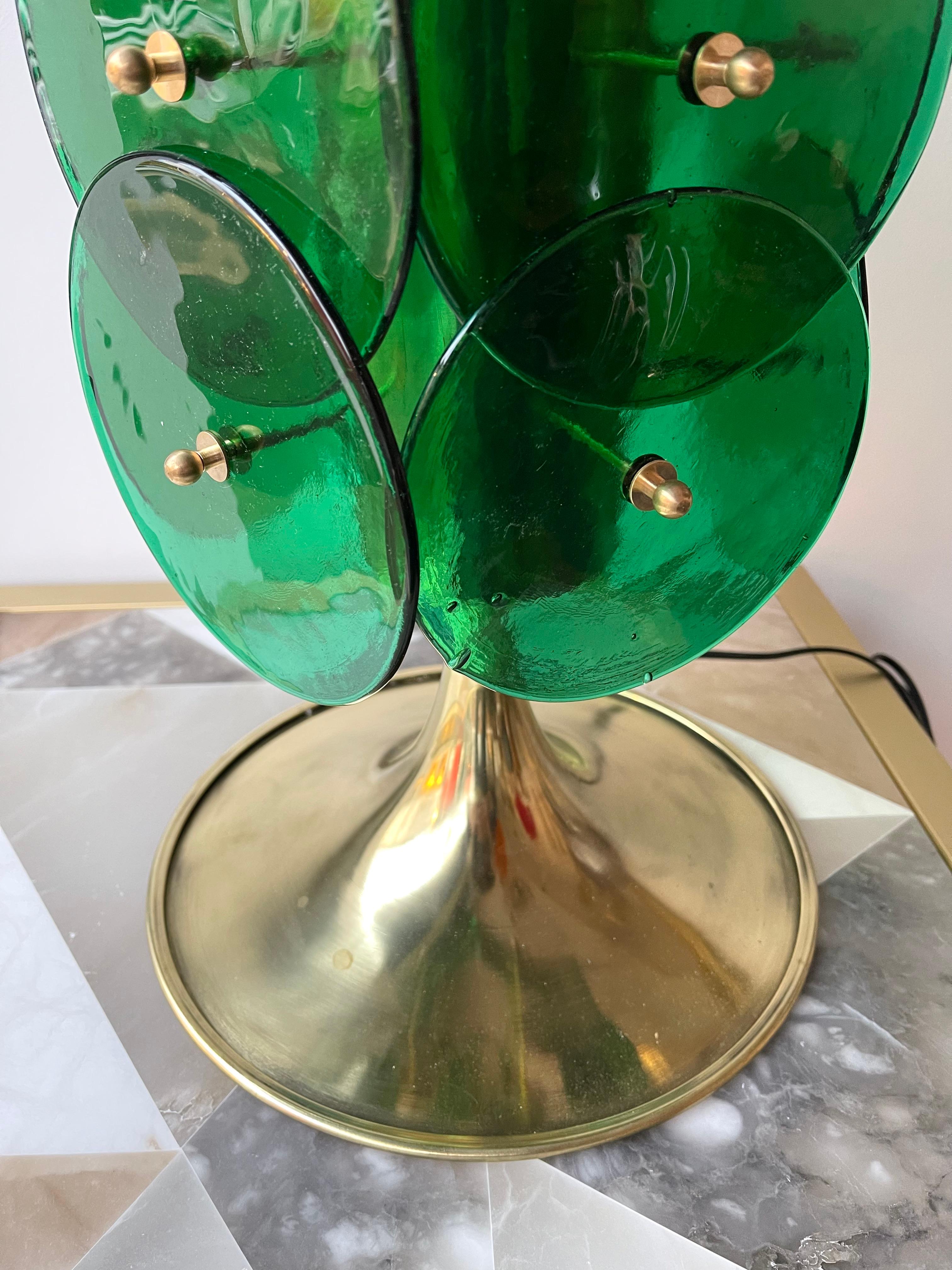 Pair of table or bedside brass lamps Murano glass disc green. Contemporary work from a small italian artisanal workshop. Made with old stock of glass from the italian design manufacture Venini.

Demo shades non included. Measurements in