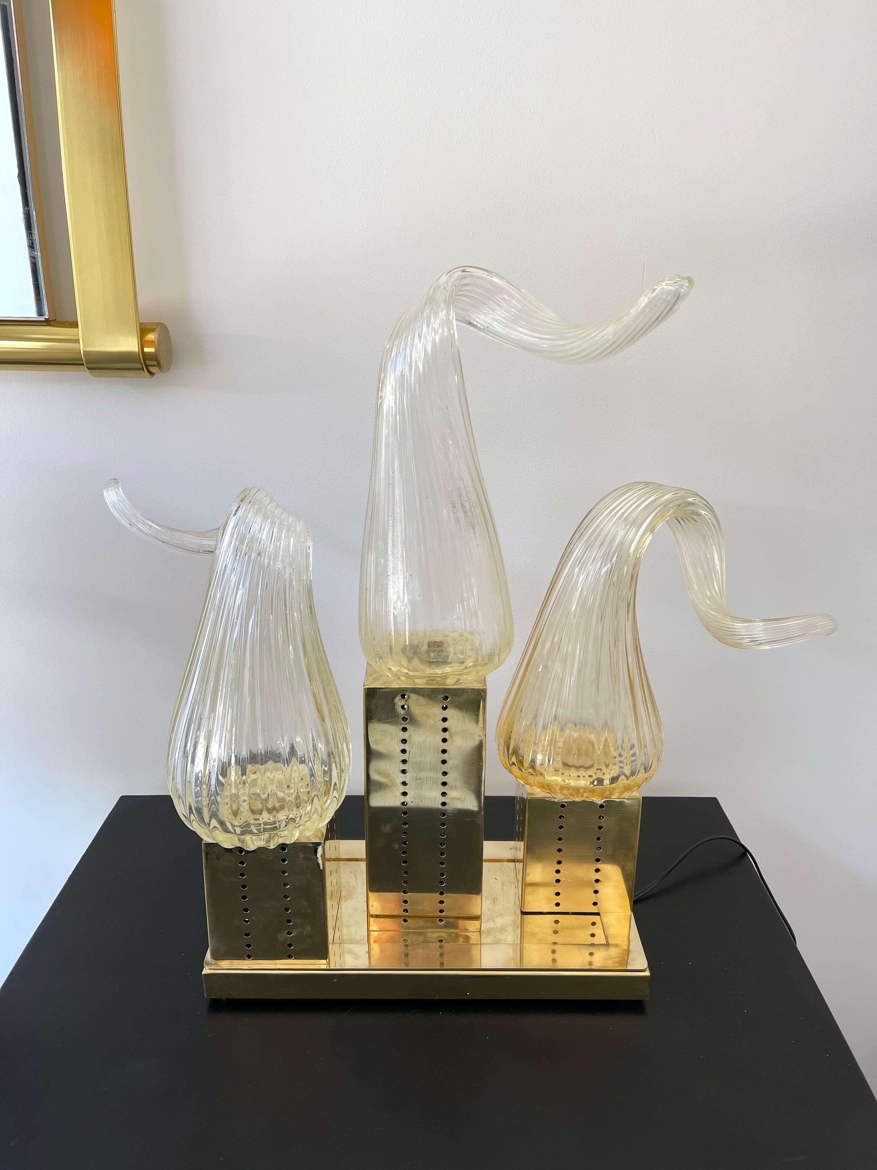 Pair of Murano glass flame and brass table or bedside lamps. Contemporary work from a small artisanal italian design workshop. Made with old stock of glass from the manufacture Seguso. Slight height difference due to artisanal curve of glass H61 and